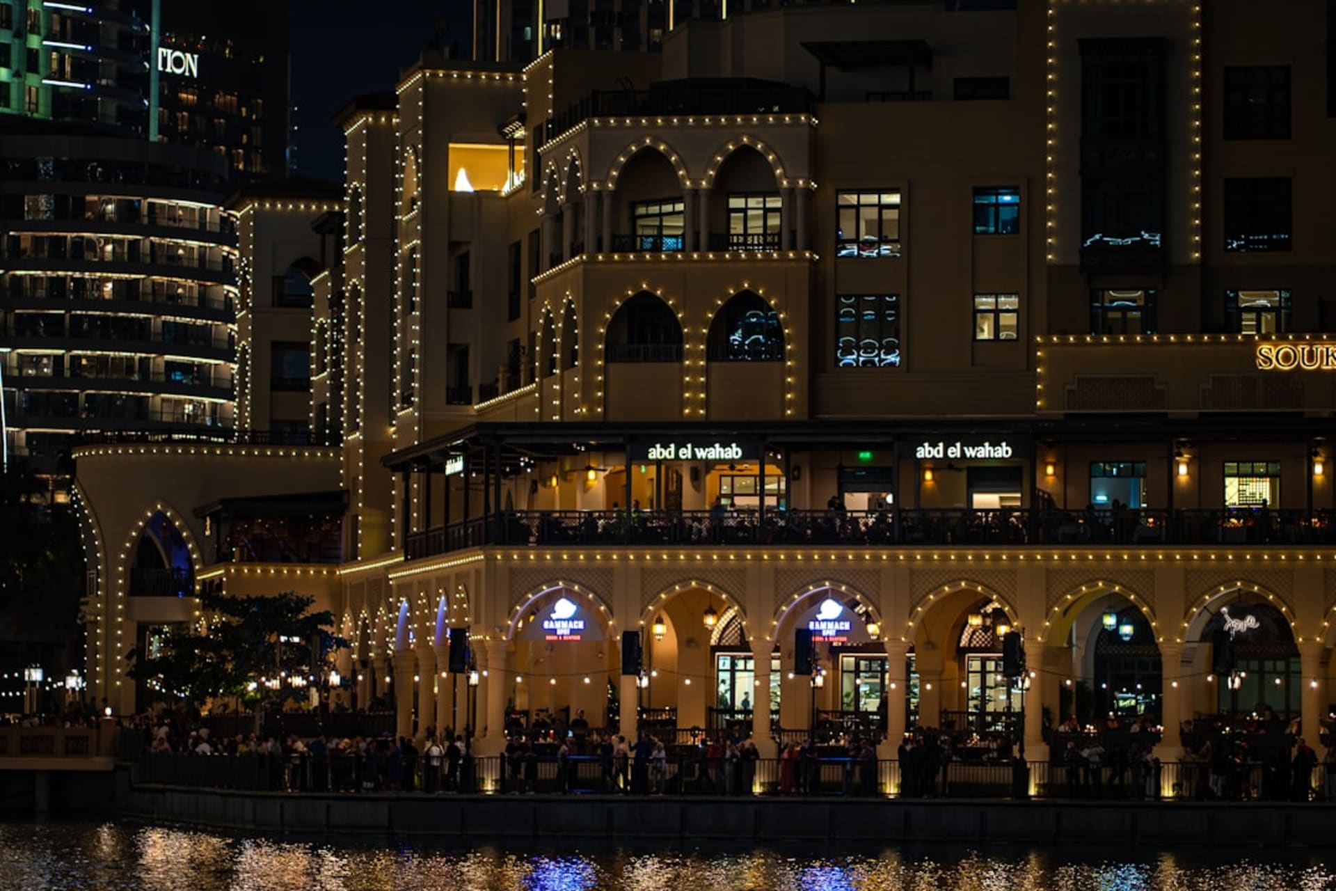 Dubai Creek at dusk with dhow boats moored along the waterfront