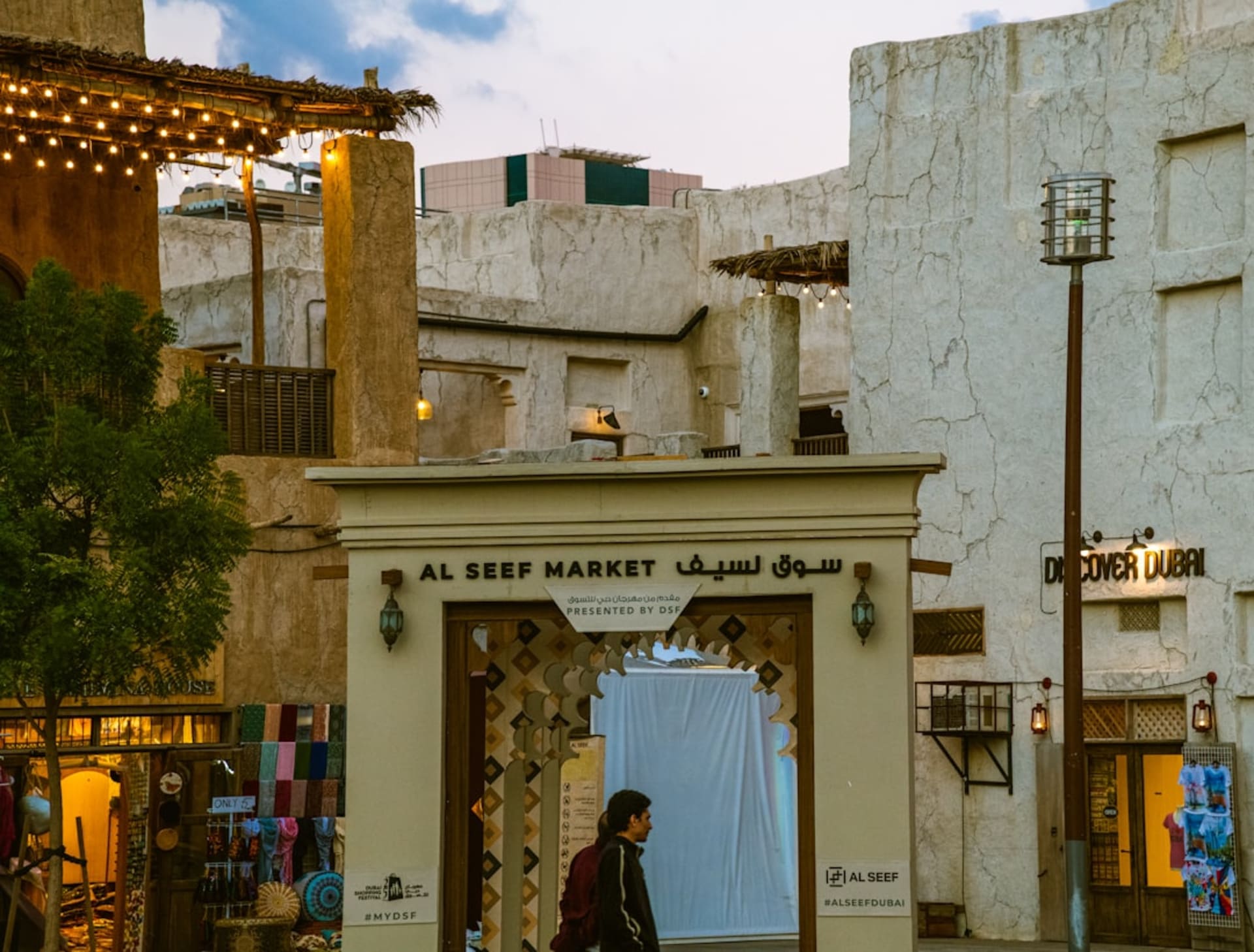 Gold jewelry displayed in shopfront windows along Dubai Gold Souk's covered alleyways