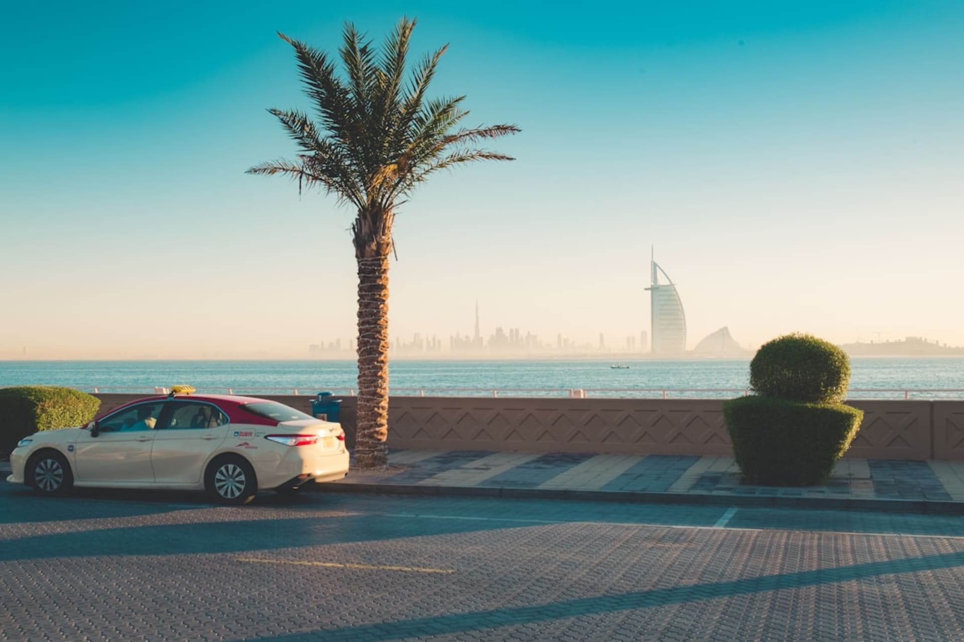 JBR Beach promenade with palm trees and the Ain Dubai observation wheel in the background