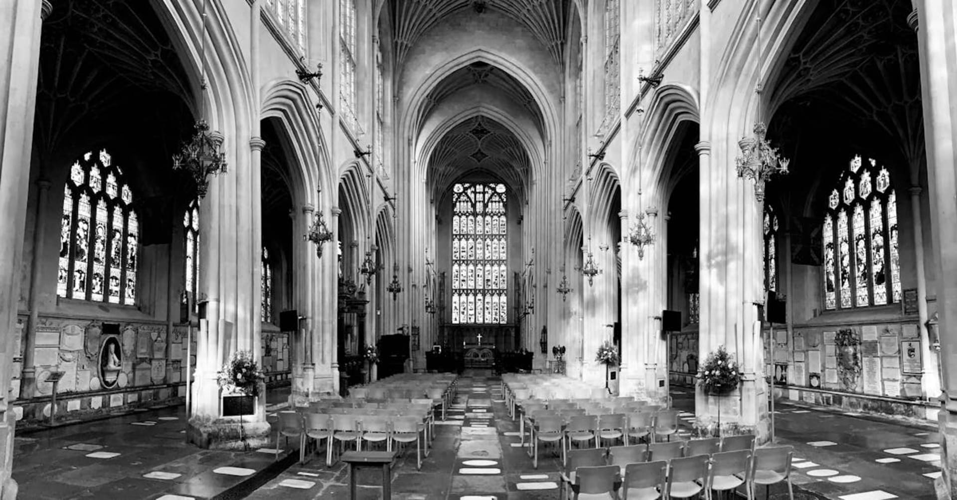 The Royal Crescent's sweeping Georgian facade in golden Bath stone under blue skies