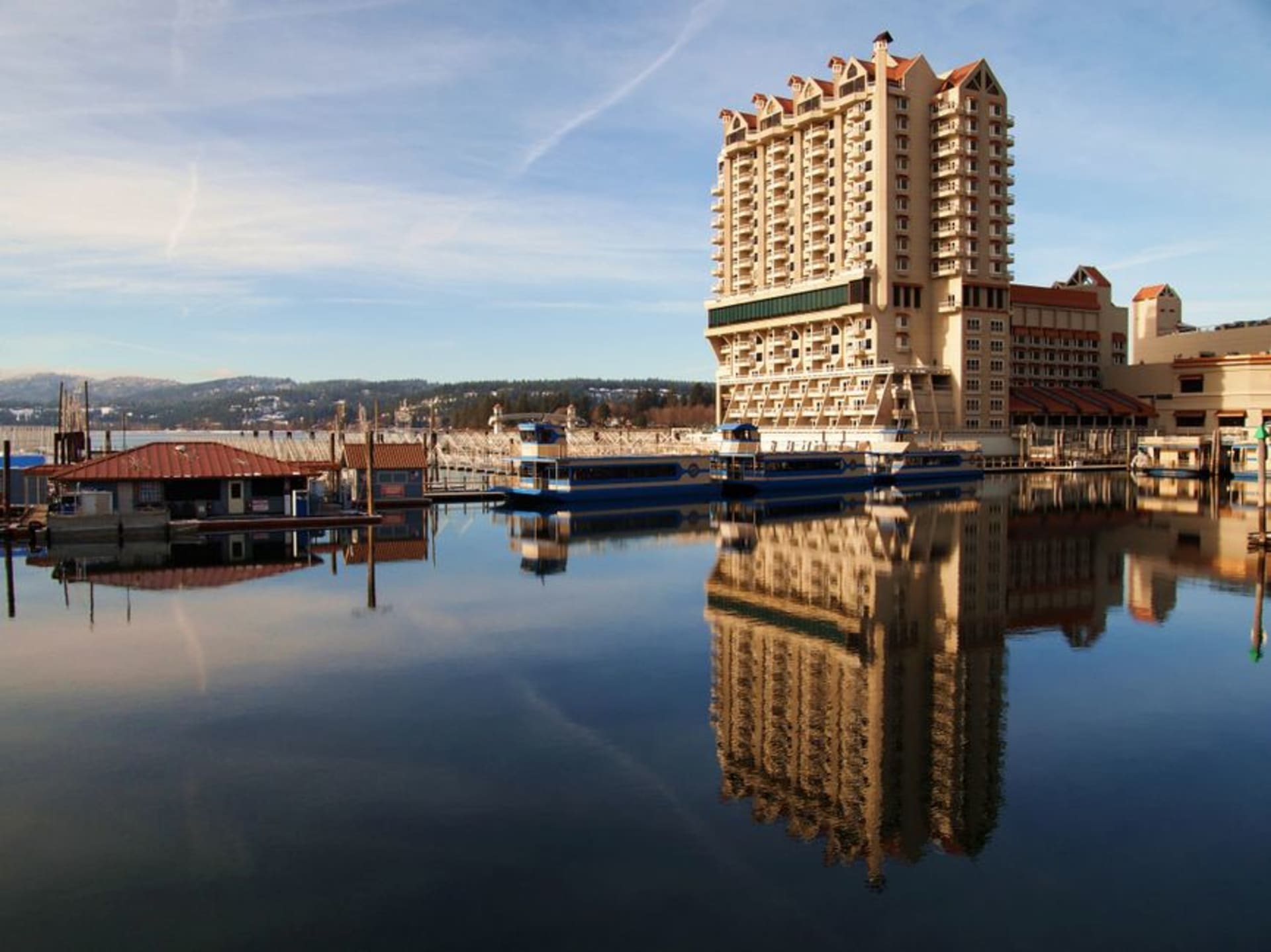 Lake Coeur d'Alene ringed by pine-covered hills under a summer sky