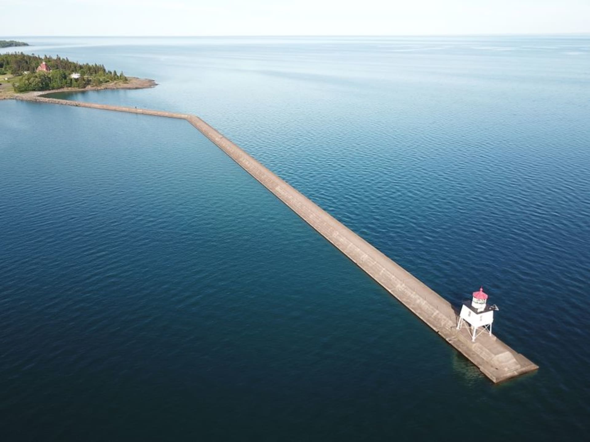 A white lighthouse on a rocky shore in Door County, Wisconsin