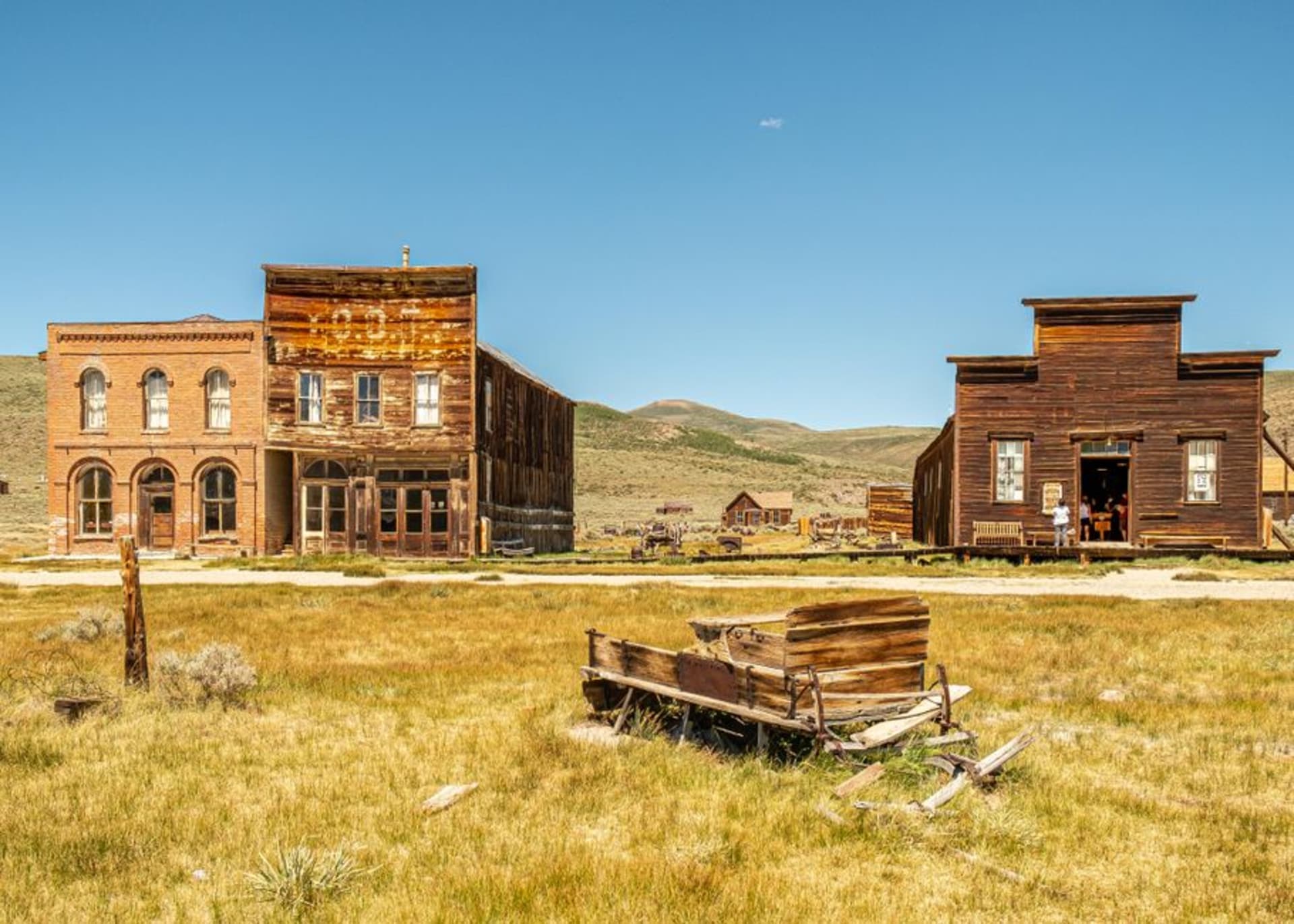 The historic Goldfield Hotel and courthouse standing among sparse buildings in Goldfield, Nevada