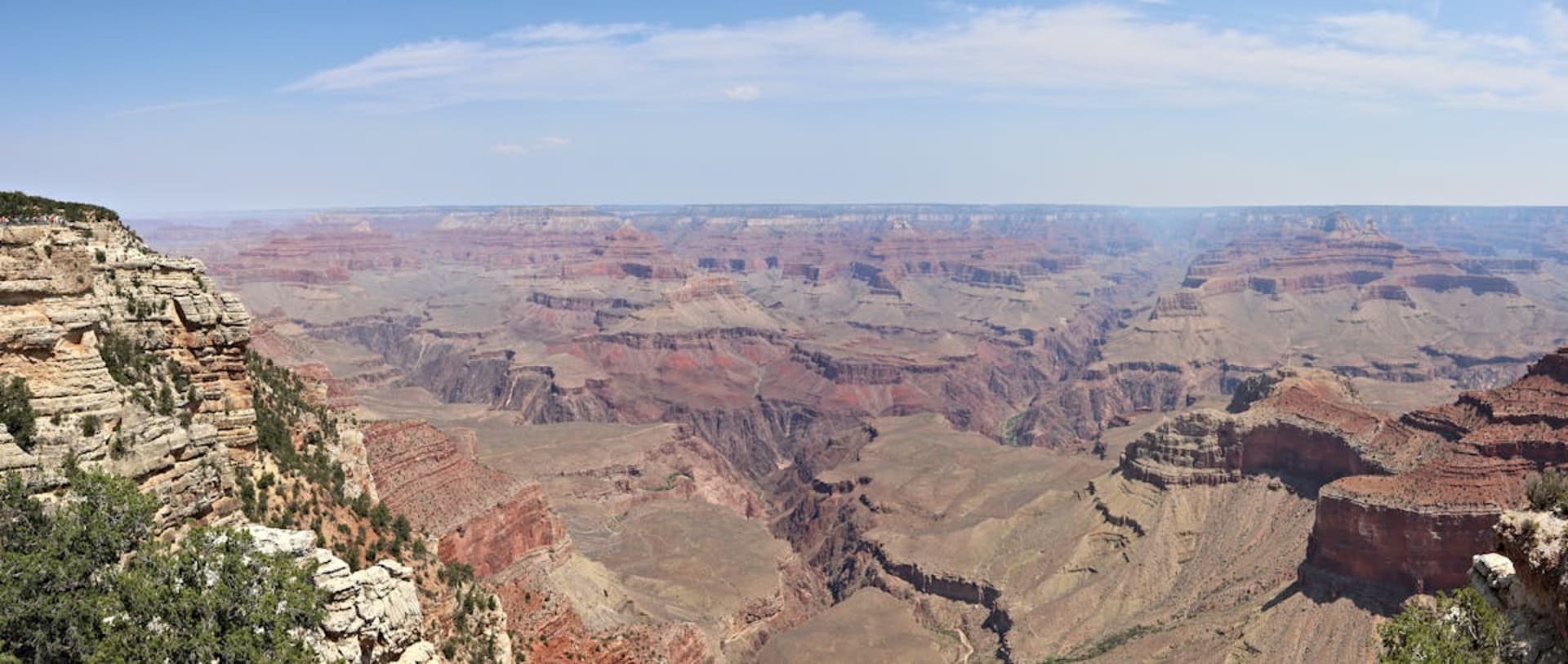 Layered red and orange rock formations of the Grand Canyon at sunrise