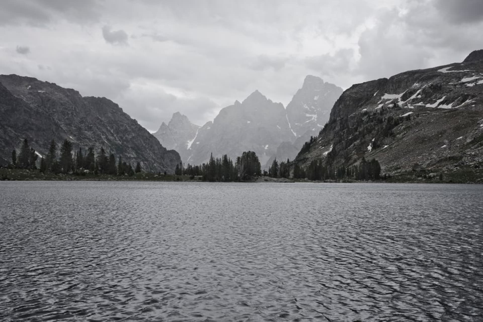The jagged peaks of the Grand Teton range rising above a glassy lake