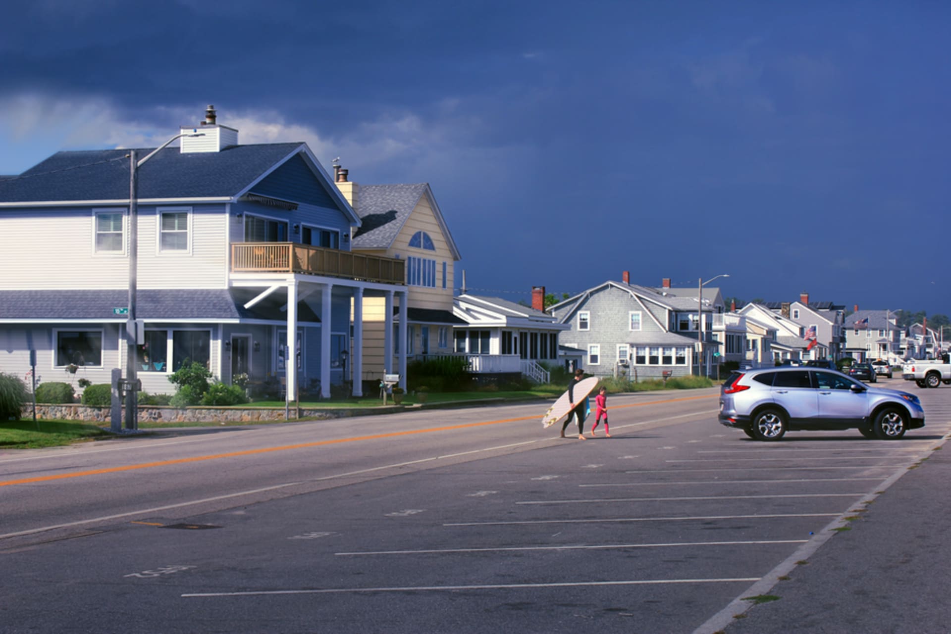 The boardwalk and beach crowds at Hampton Beach, New Hampshire on a summer evening