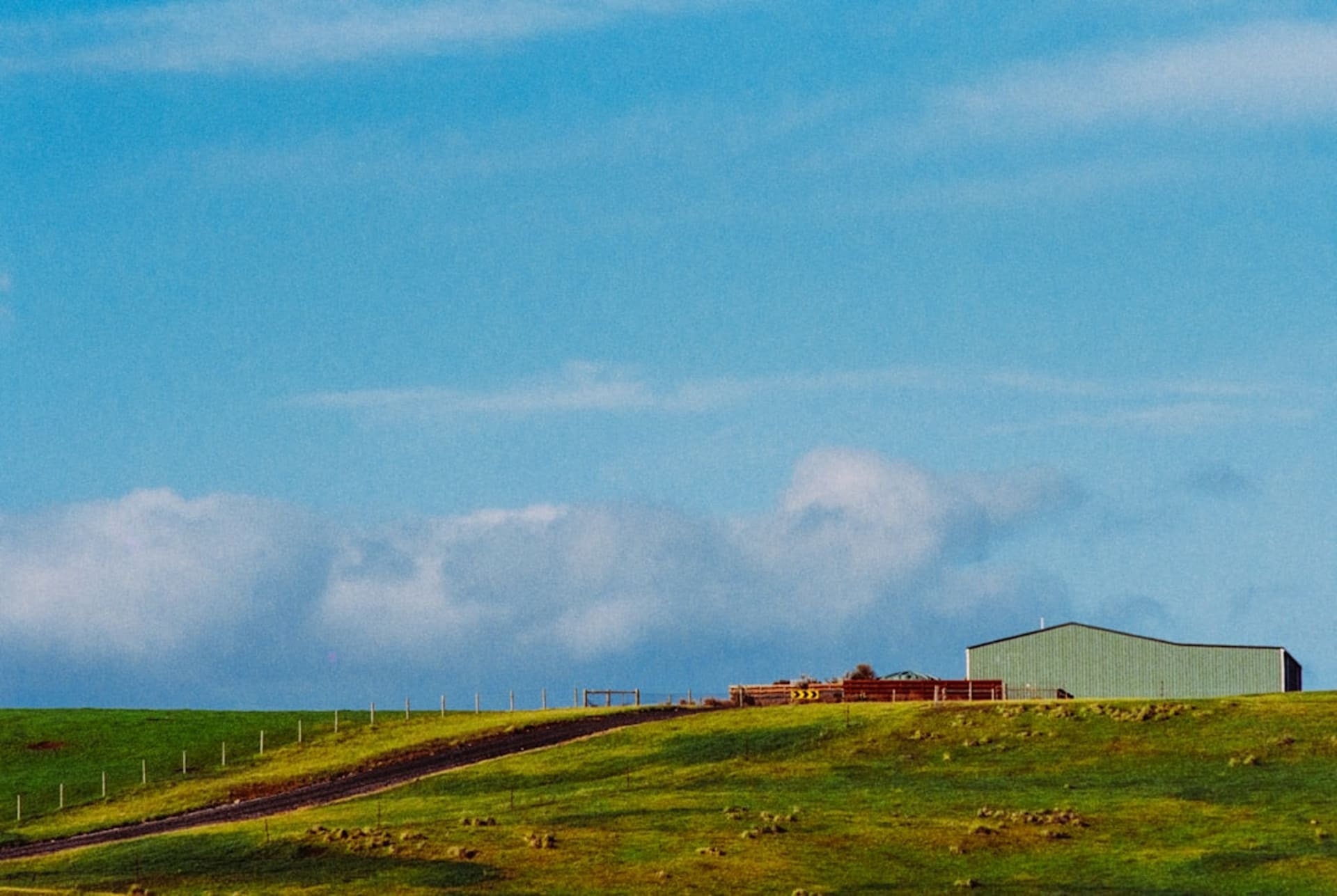 Stone walls and rolling farmland under a summer sky in Little Compton, Rhode Island