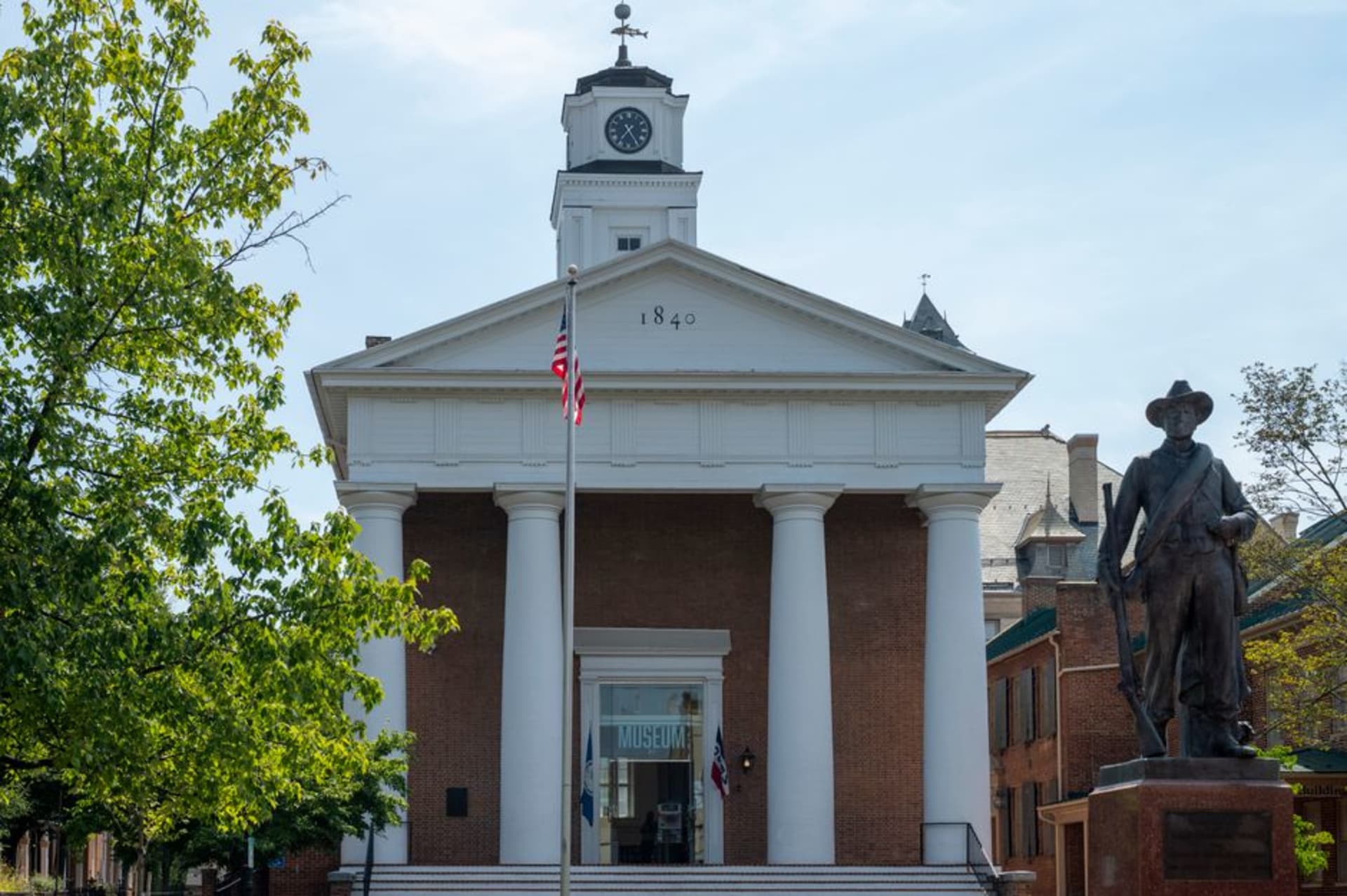The bronze Superman statue in downtown Metropolis, Illinois with the courthouse behind it
