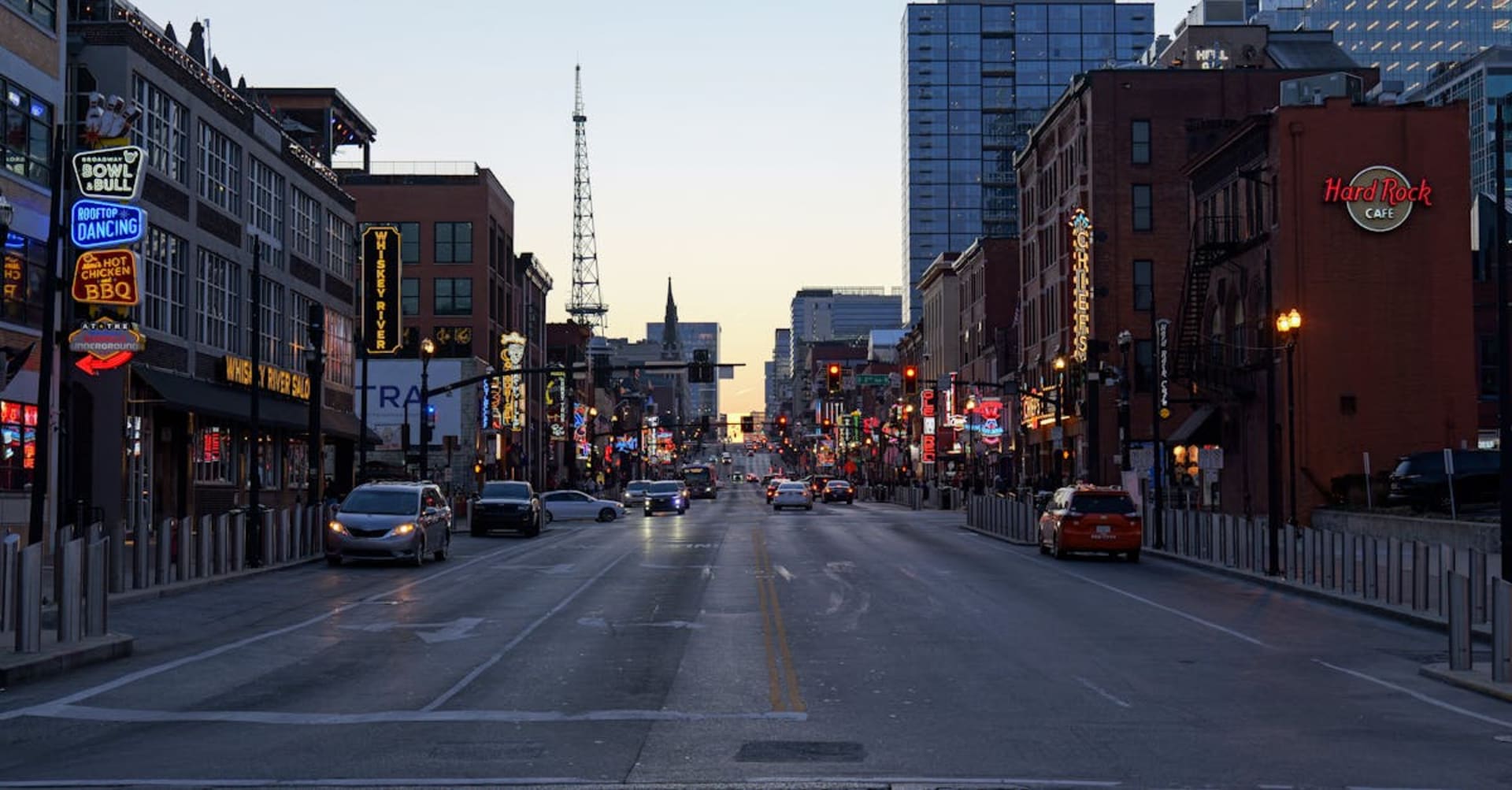 Neon signs lighting up Broadway in downtown Nashville at night