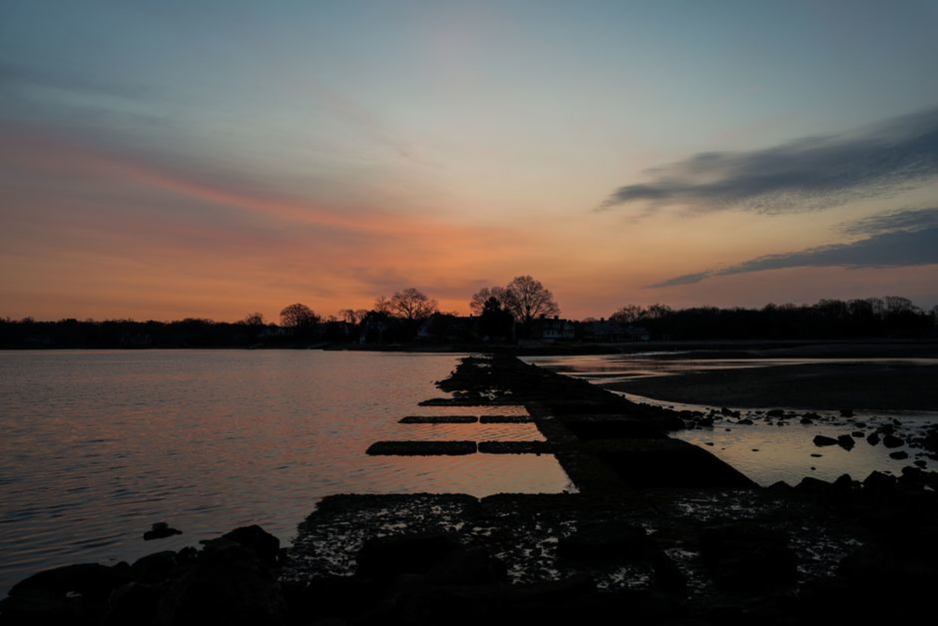 Sunset over Niantic Bay with the boardwalk and beach in East Lyme, Connecticut