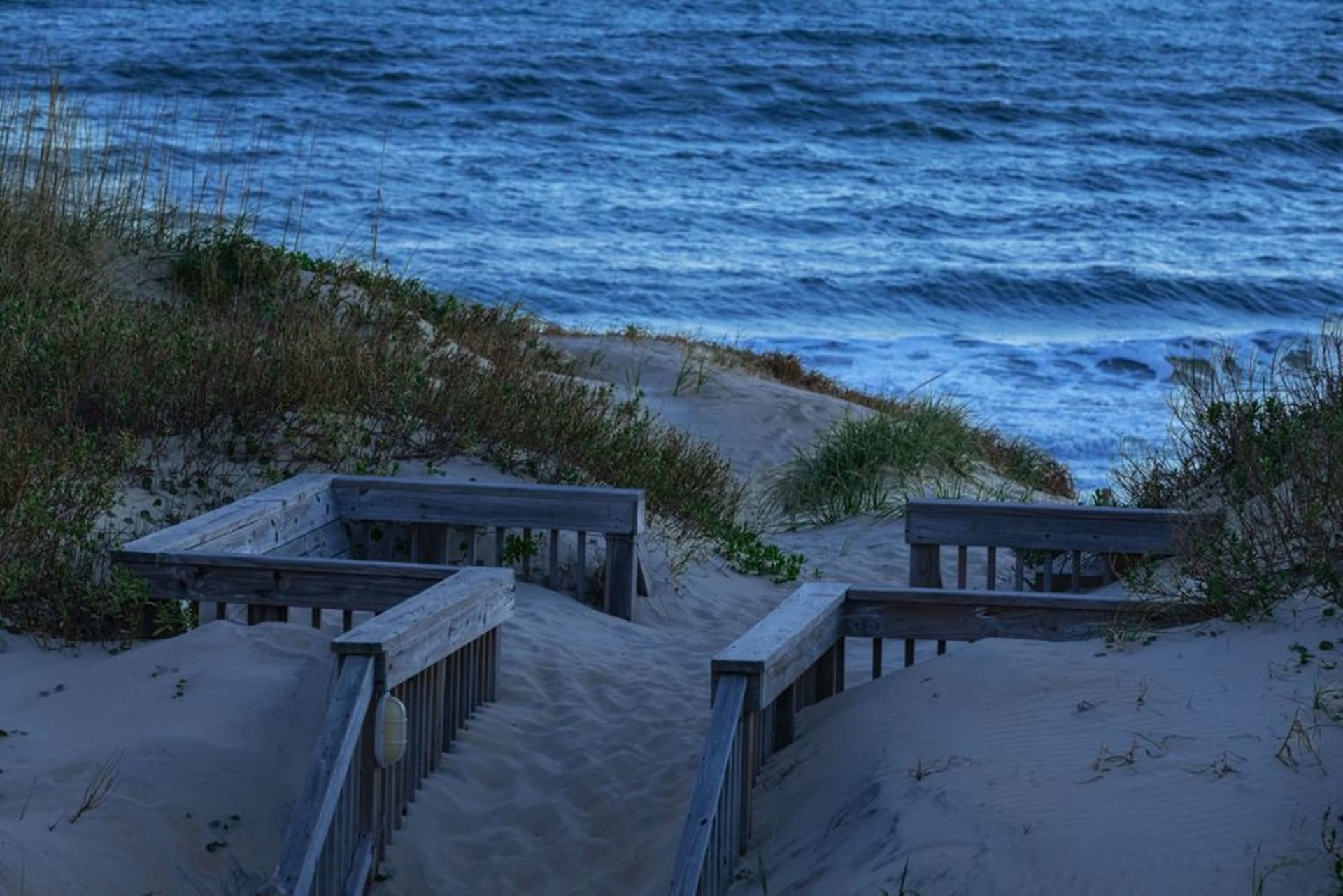 The black-and-white spiral of Cape Hatteras Lighthouse rising above the dunes