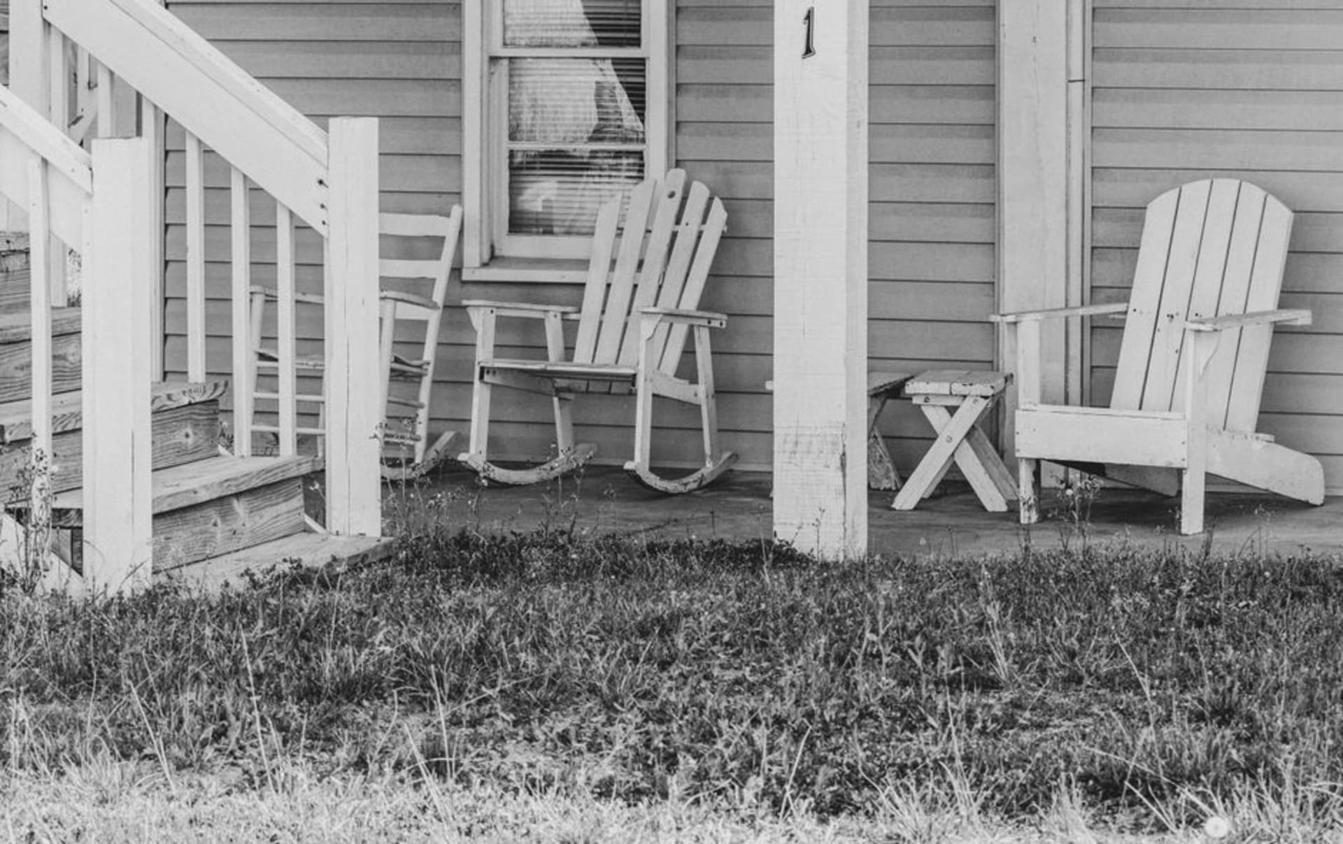 A weathered beach cottage on stilts with a rope hammock on the porch at Pawleys Island, South Carolina