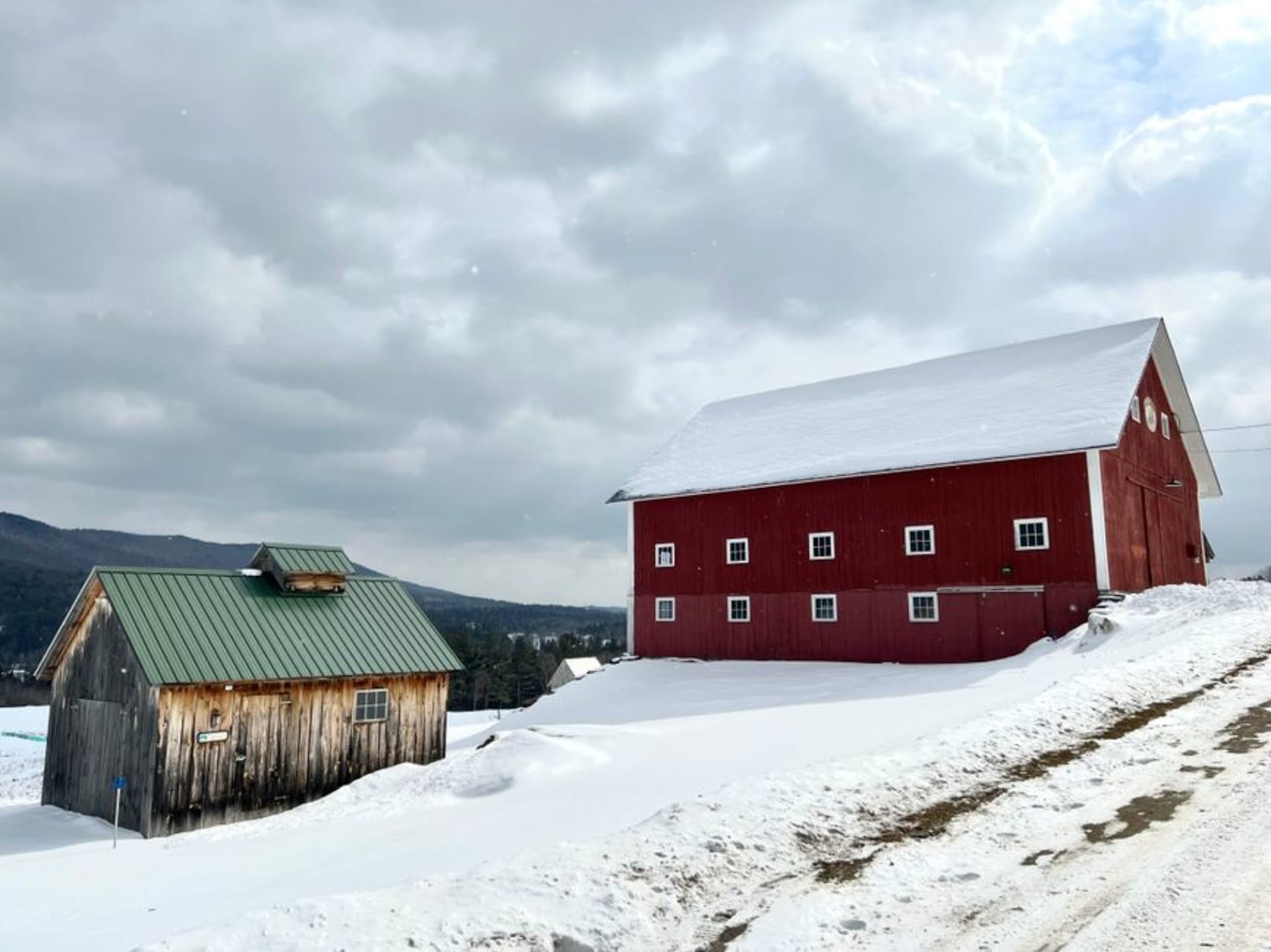 Shelburne Farms barn overlooking Lake Champlain in Vermont with the Adirondacks in the distance