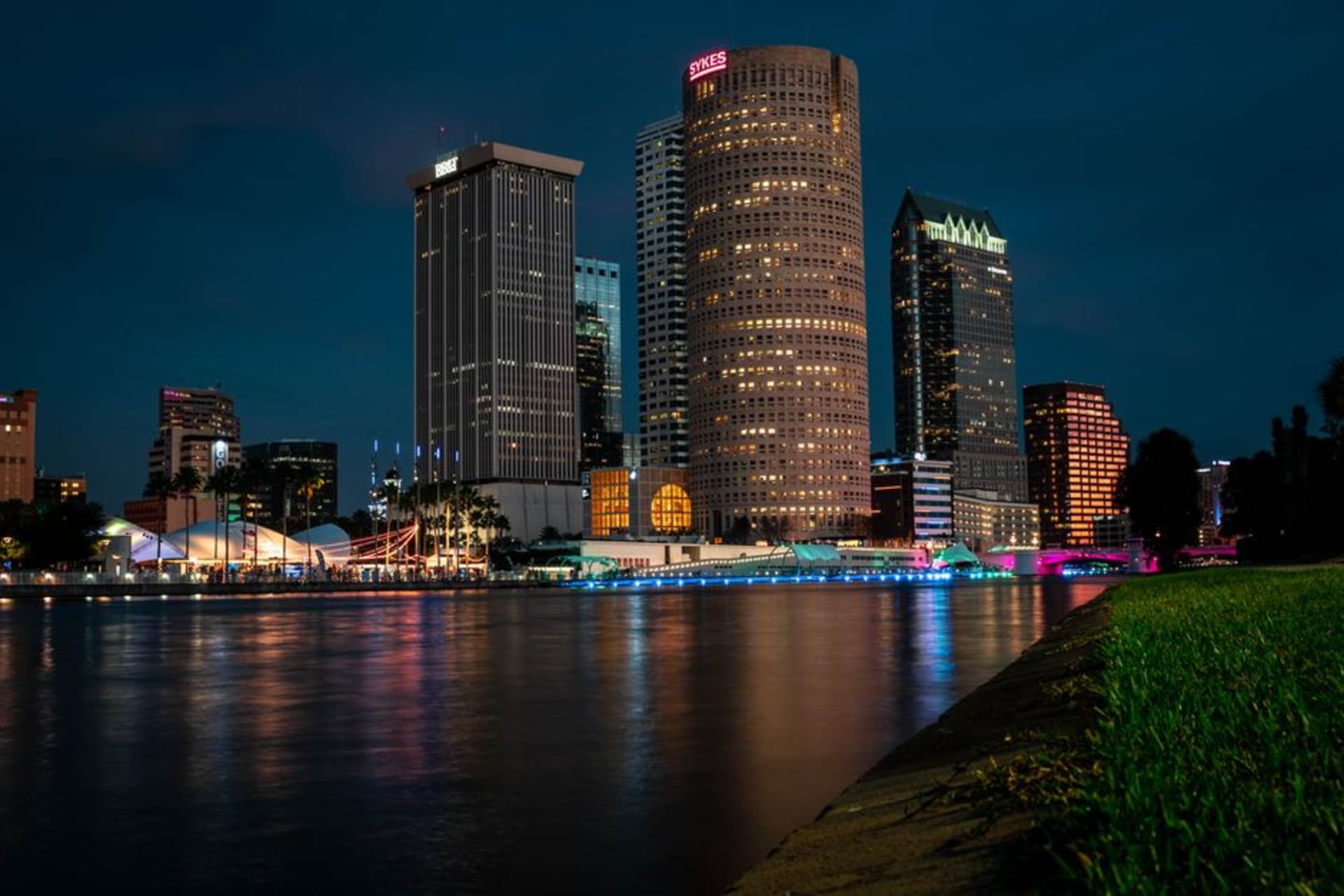 Tampa's downtown skyline and riverwalk along the Hillsborough River at sunset
