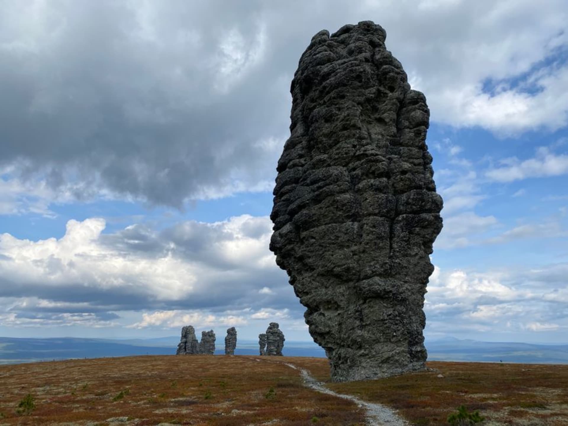 The seven Manpupuner rock pillars rising from the remote Ural plateau under a wide sky