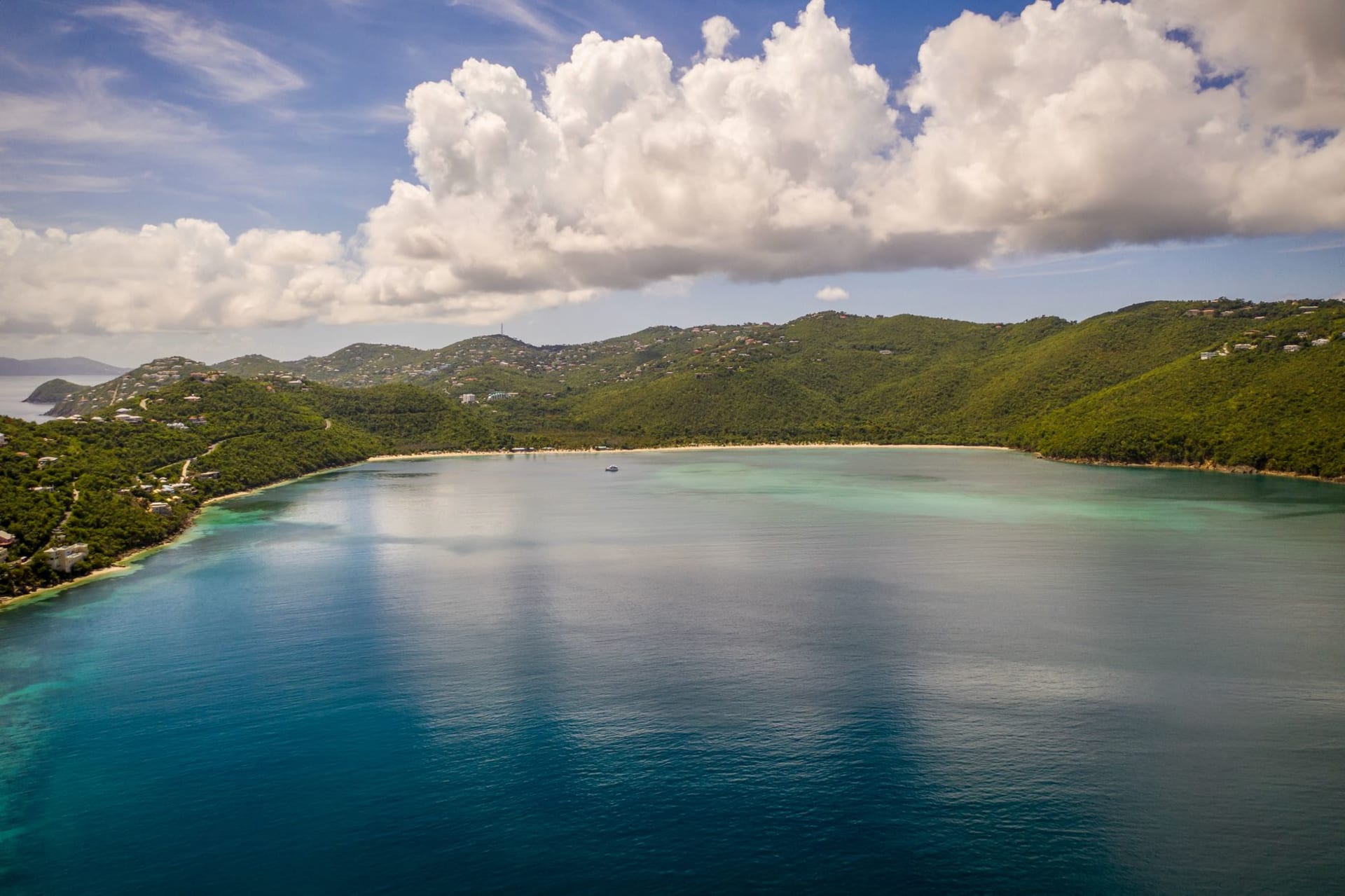 Sailboats moored in the calm protected waters of Coral Bay, St. John, surrounded by steep green hills