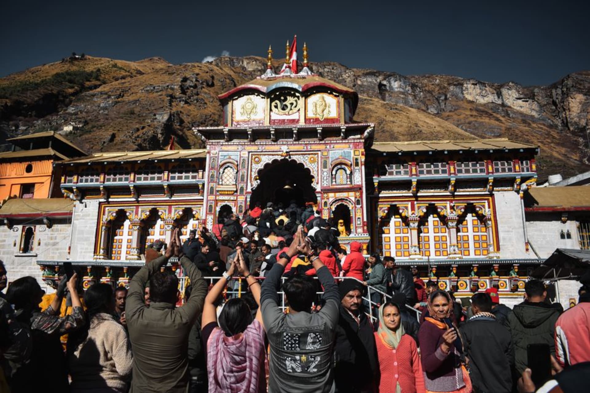 The golden facade of Badrinath Temple against snow-dusted Himalayan peaks