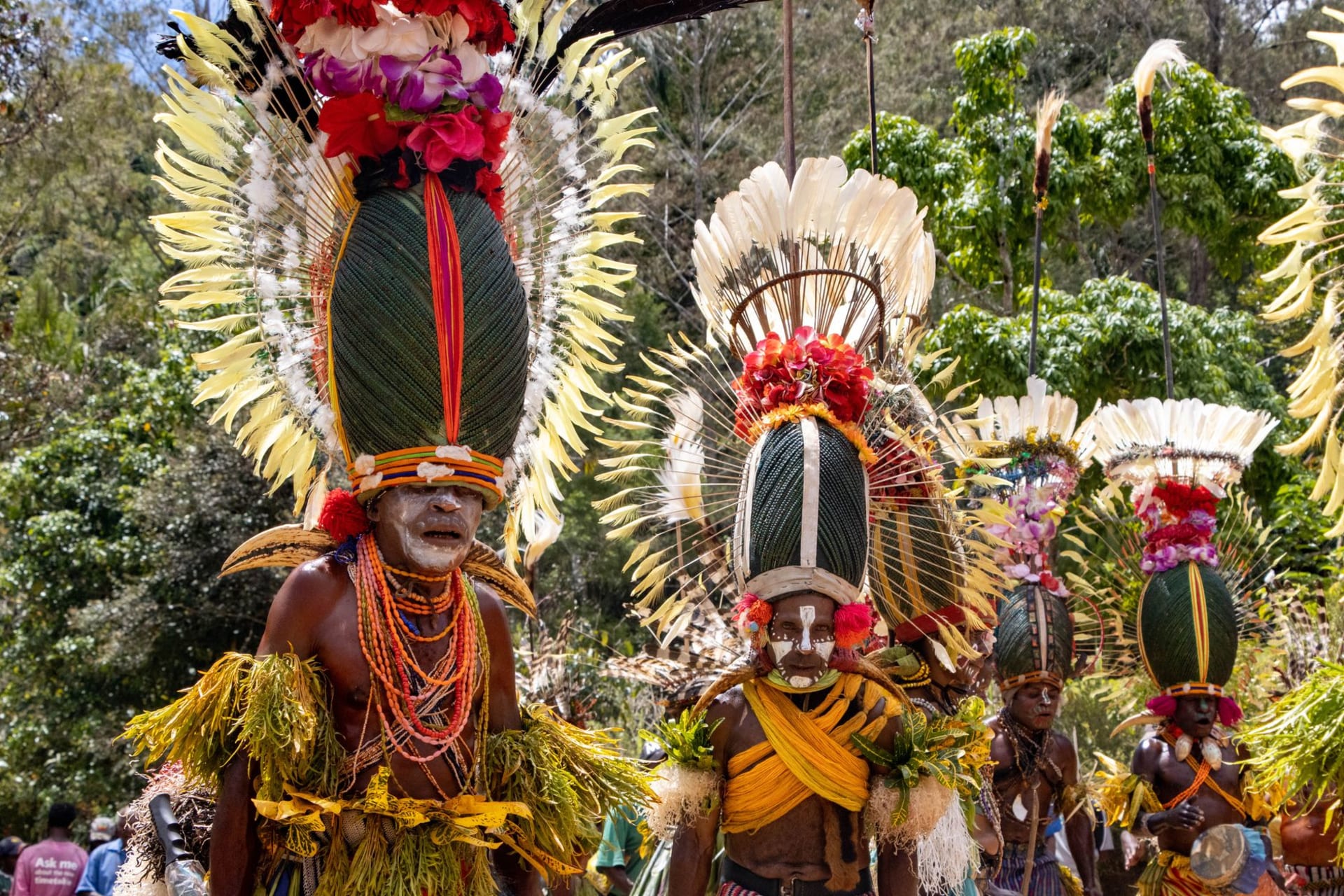Traditional village in Malekula with thatched nakamal and men in kastom dress standing among breadfruit trees