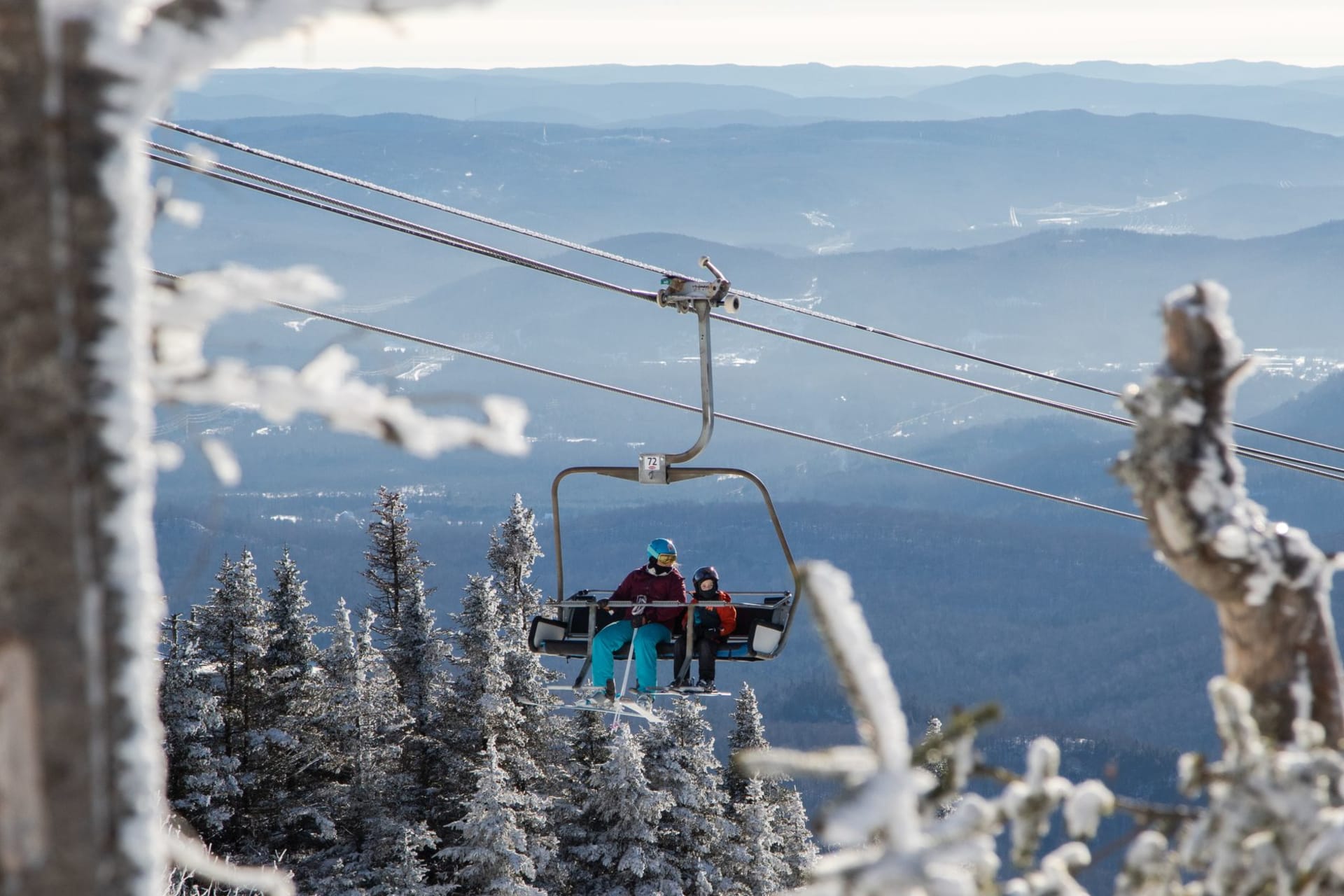 Killington Peak at sunrise with ski runs carved through snow-dusted forest, Long Trail visible on the ridgeline
