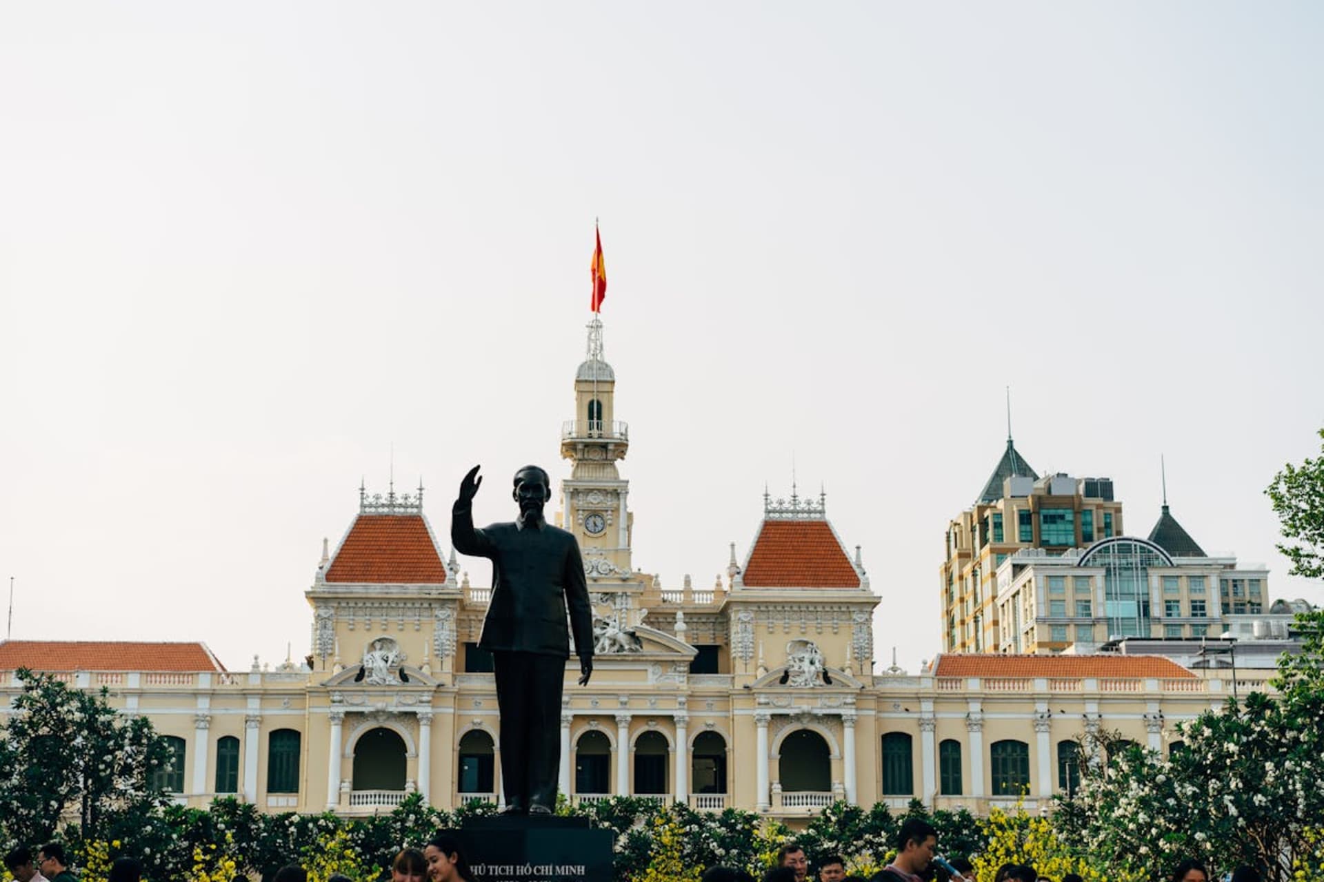 Bustling street scene in Ho Chi Minh City with colonial buildings and neon signs