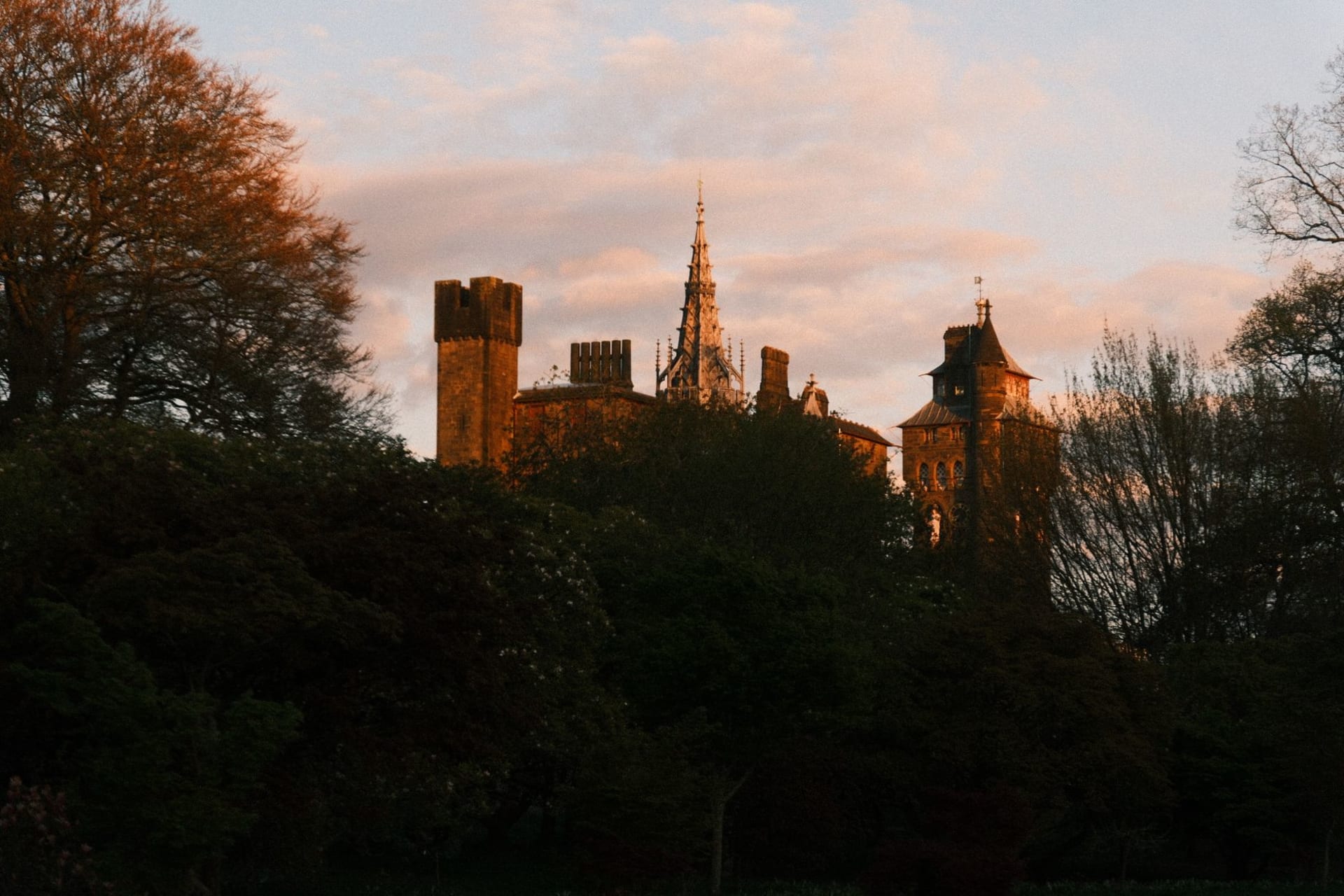 Cardiff Castle's clock tower rising above the city centre against a pewter Welsh sky