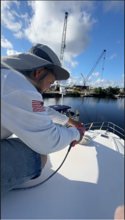 Alex buffing a boat hull Tampa Bay