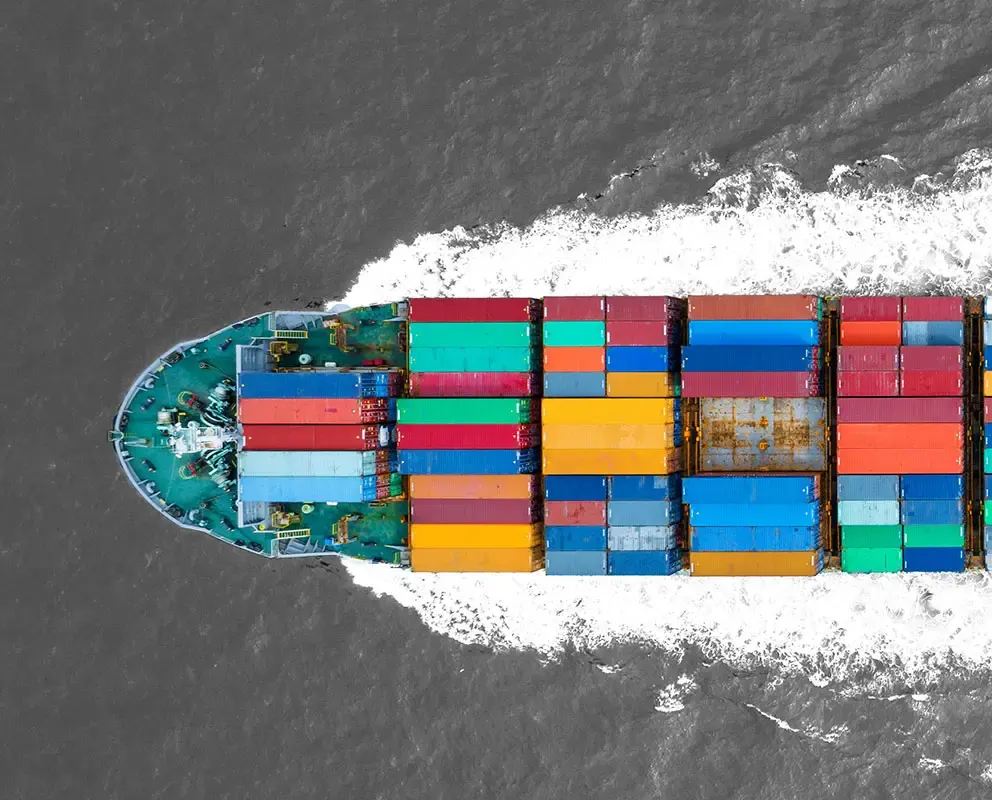 A container ship on the ocean, carrying cargo for global logistics.