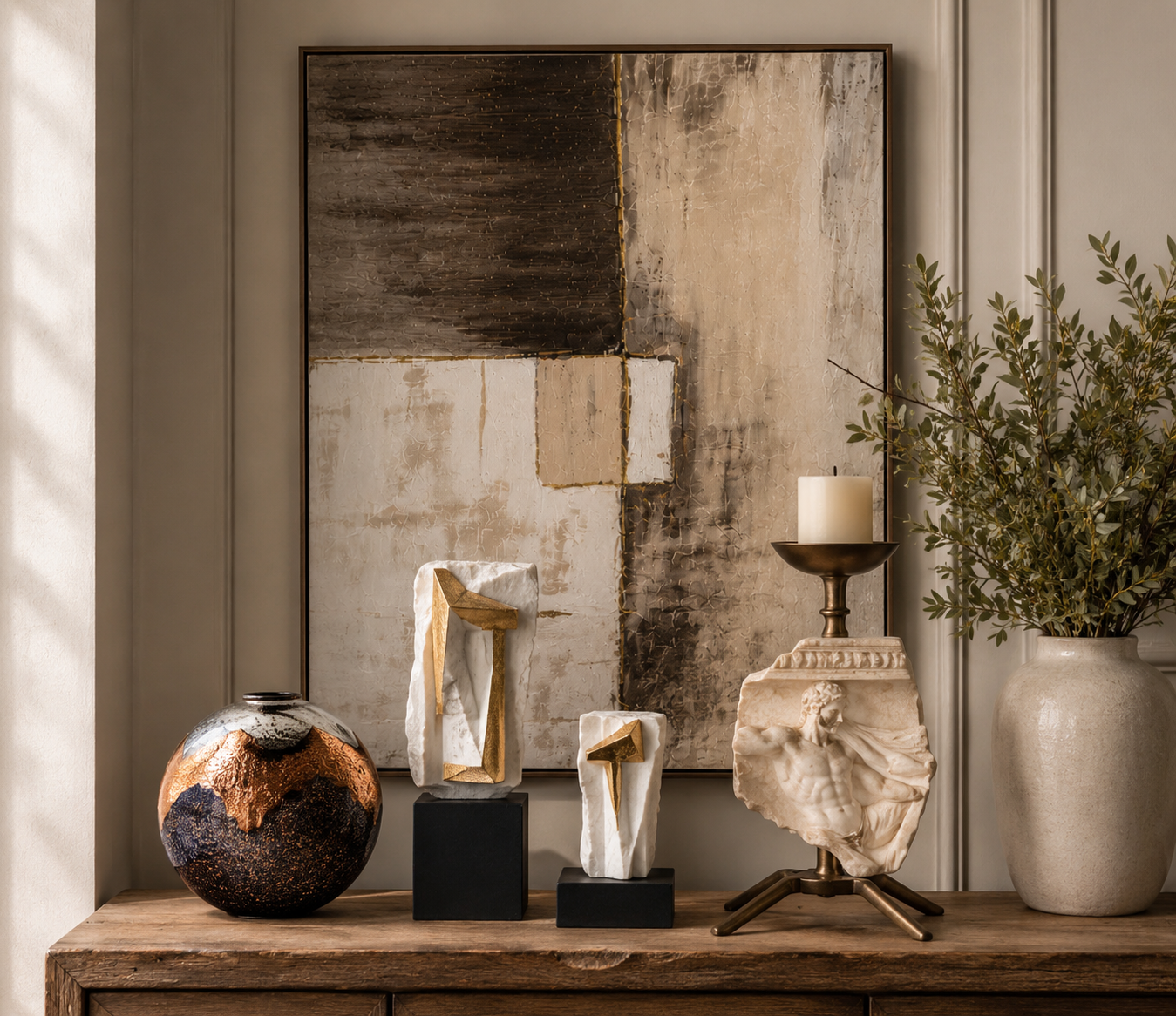 Styled console with vase, sculptures and candle holder