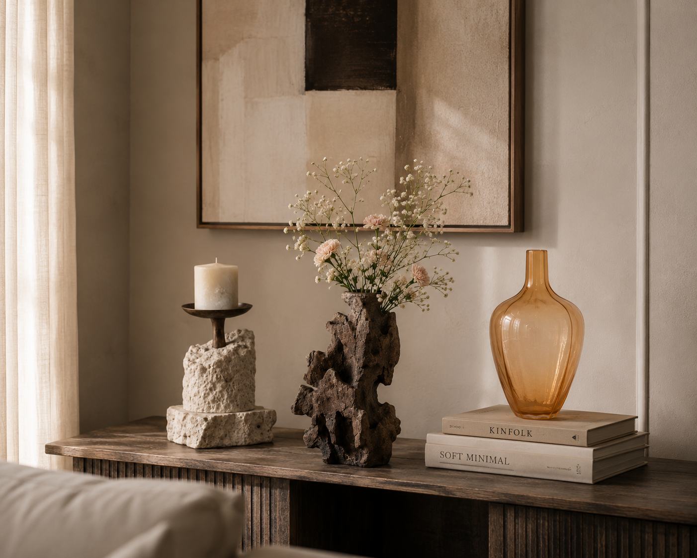 Styled console with candle holder, bark vase and amber vase