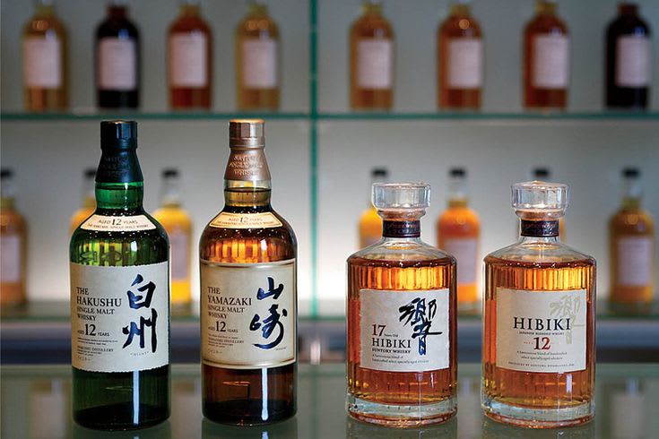 Selection of world whisky bottles including Japanese and Taiwanese single malts on a shelf