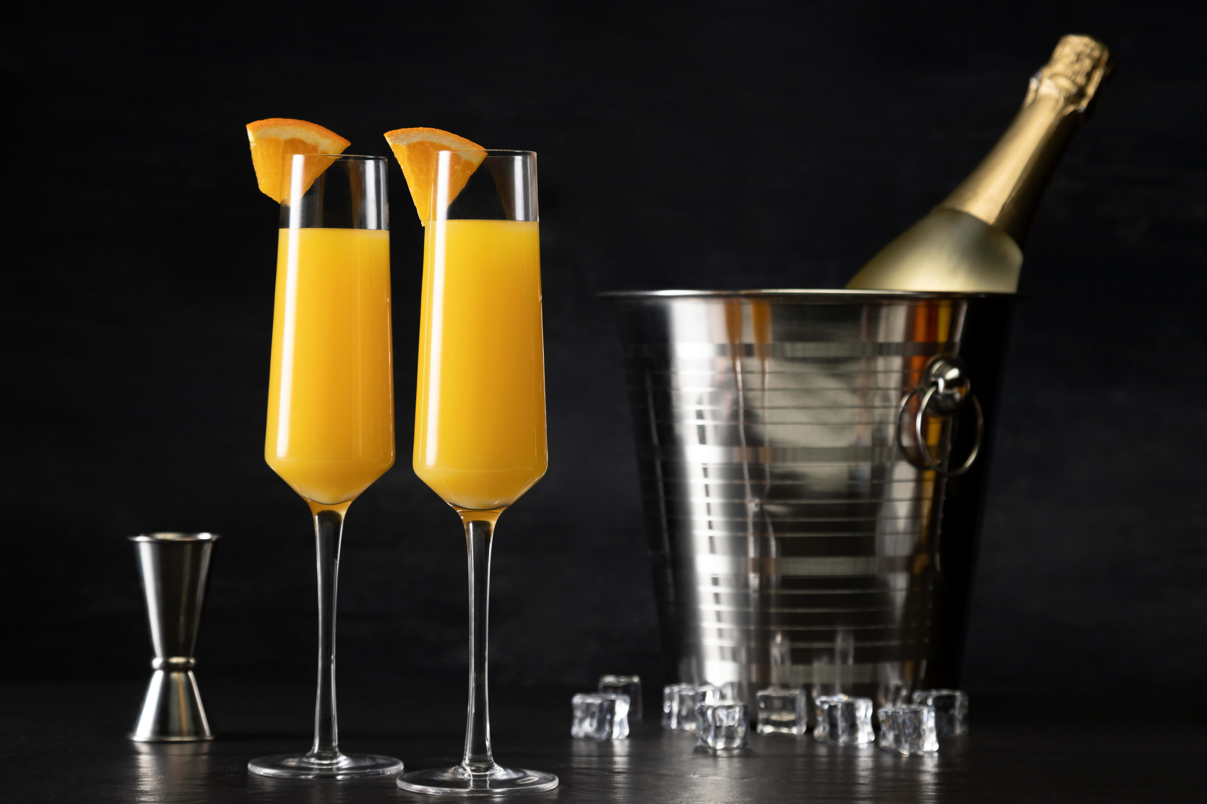 Colorful Nigerian house party setup with champagne bottles, glasses, and guests mingling