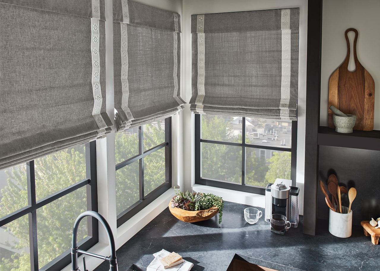 Tailored Roman shades in a bedroom