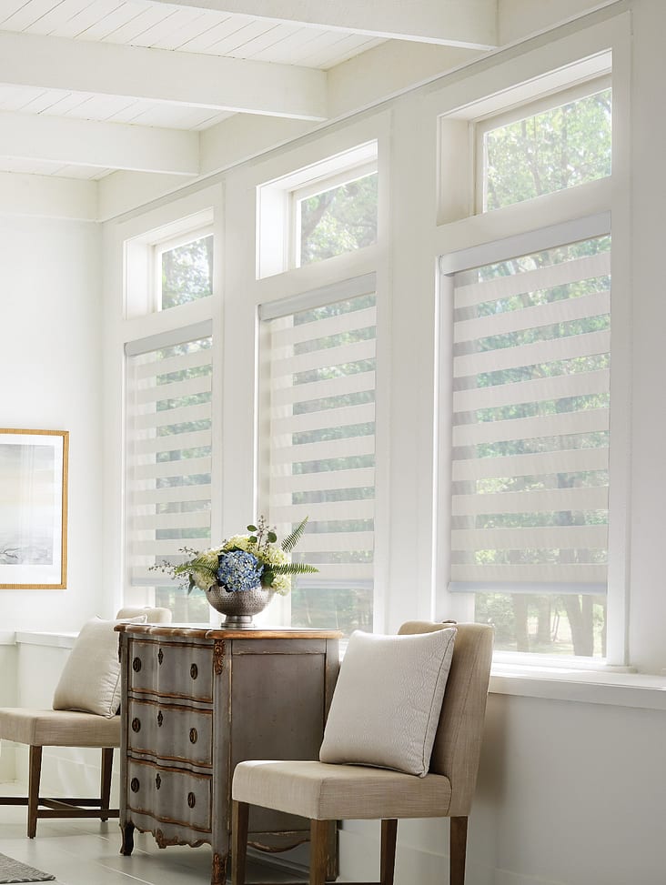 Cellular shades installed above a sofa with pillows