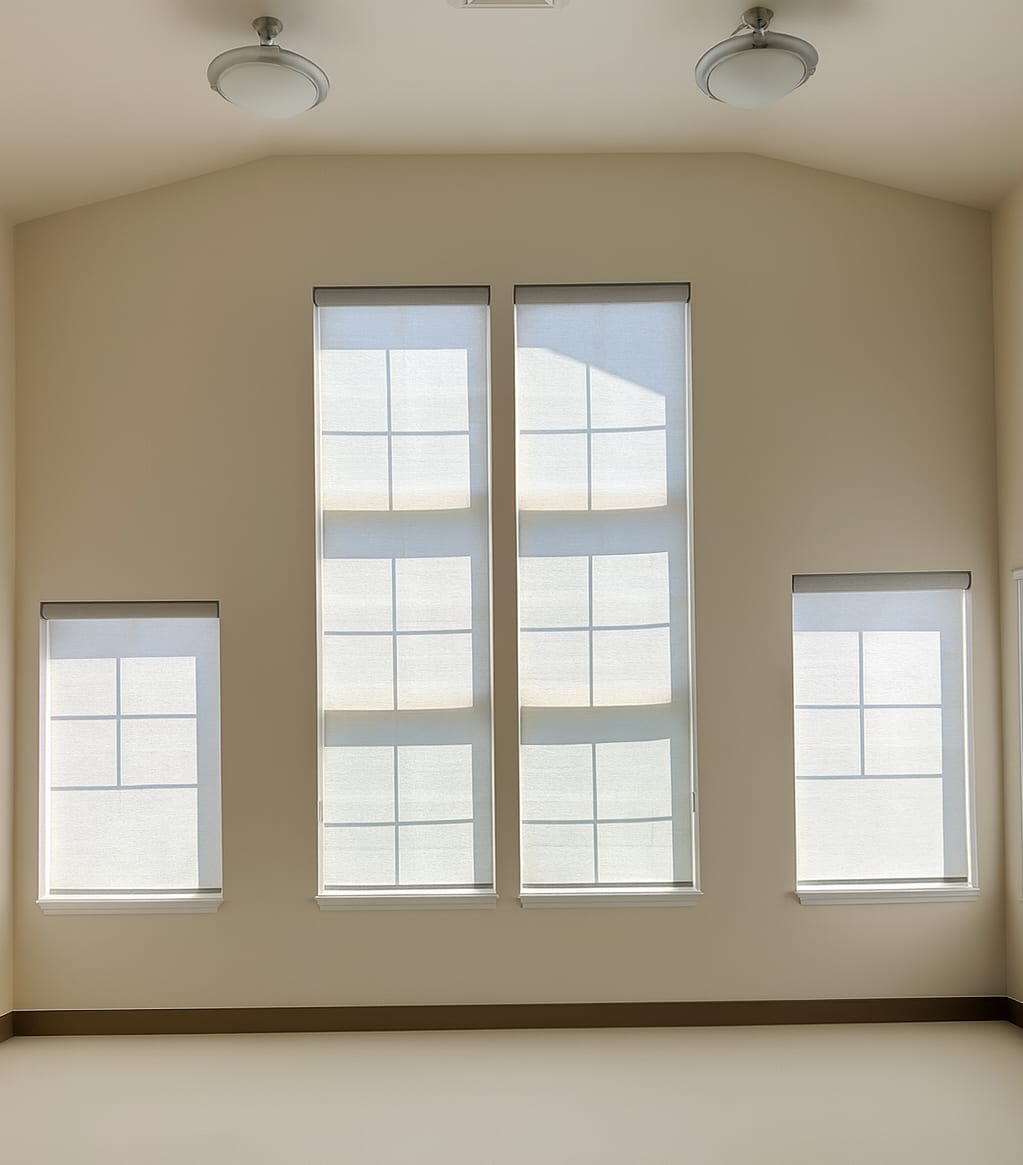 Modern roller shades in three windows