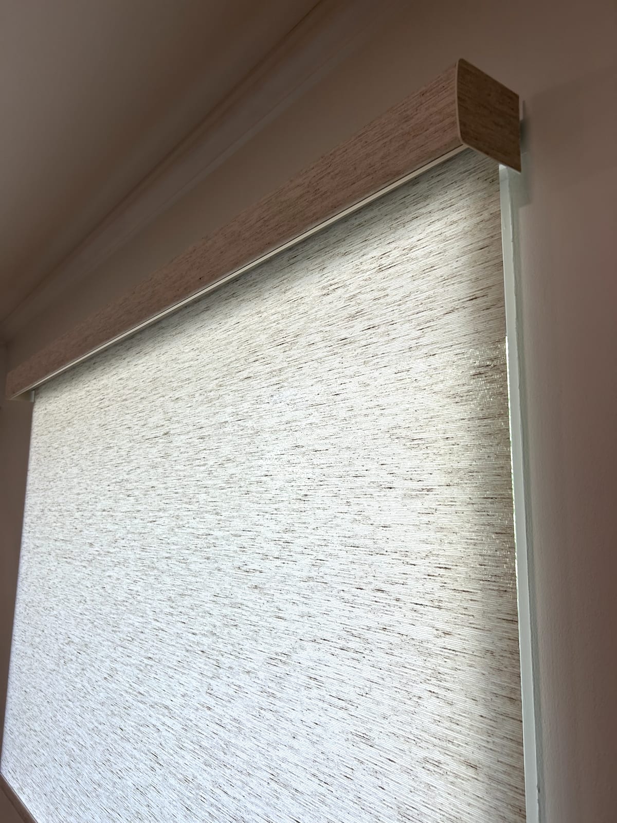 Roller shades in four windows inside country club