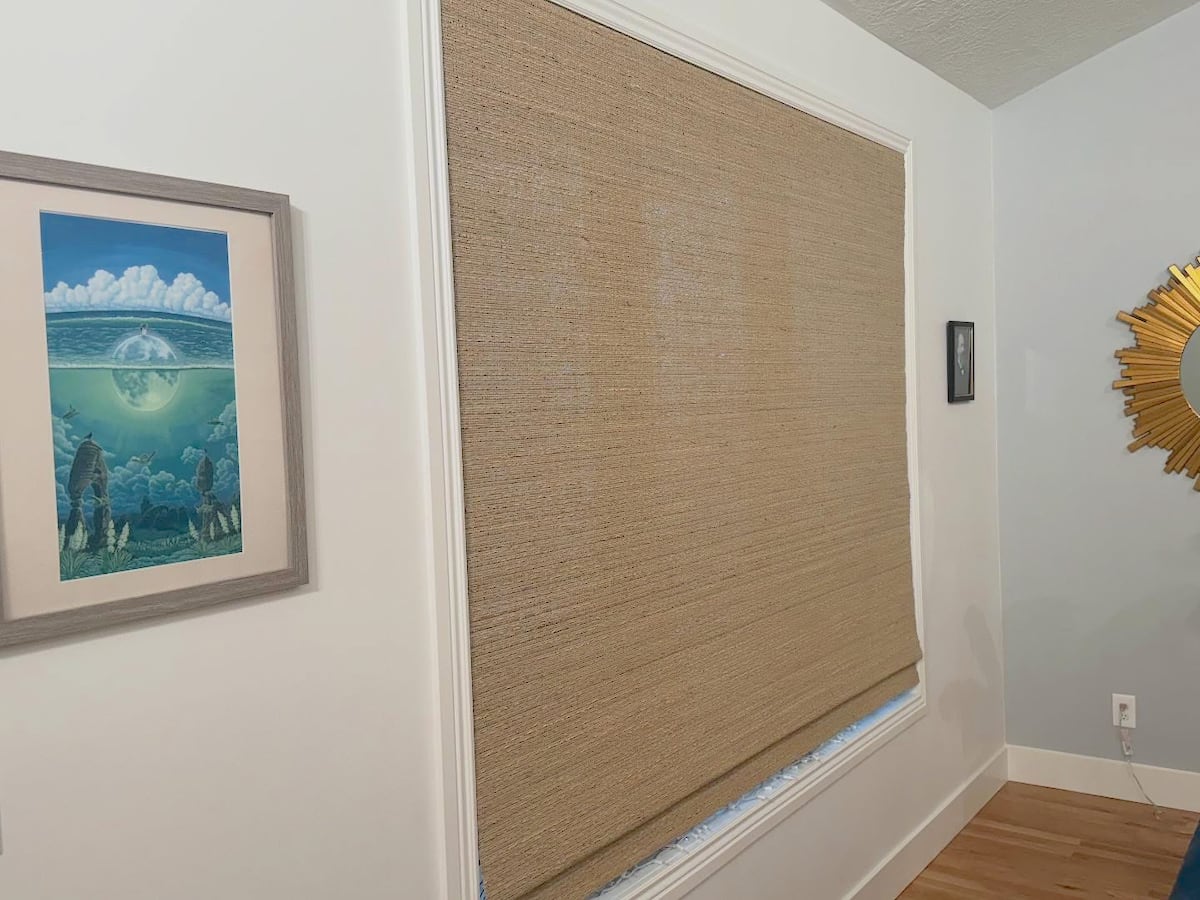 Roller shades in four windows inside country club