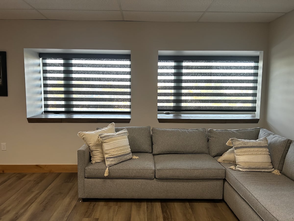 Roller shades in four windows inside country club