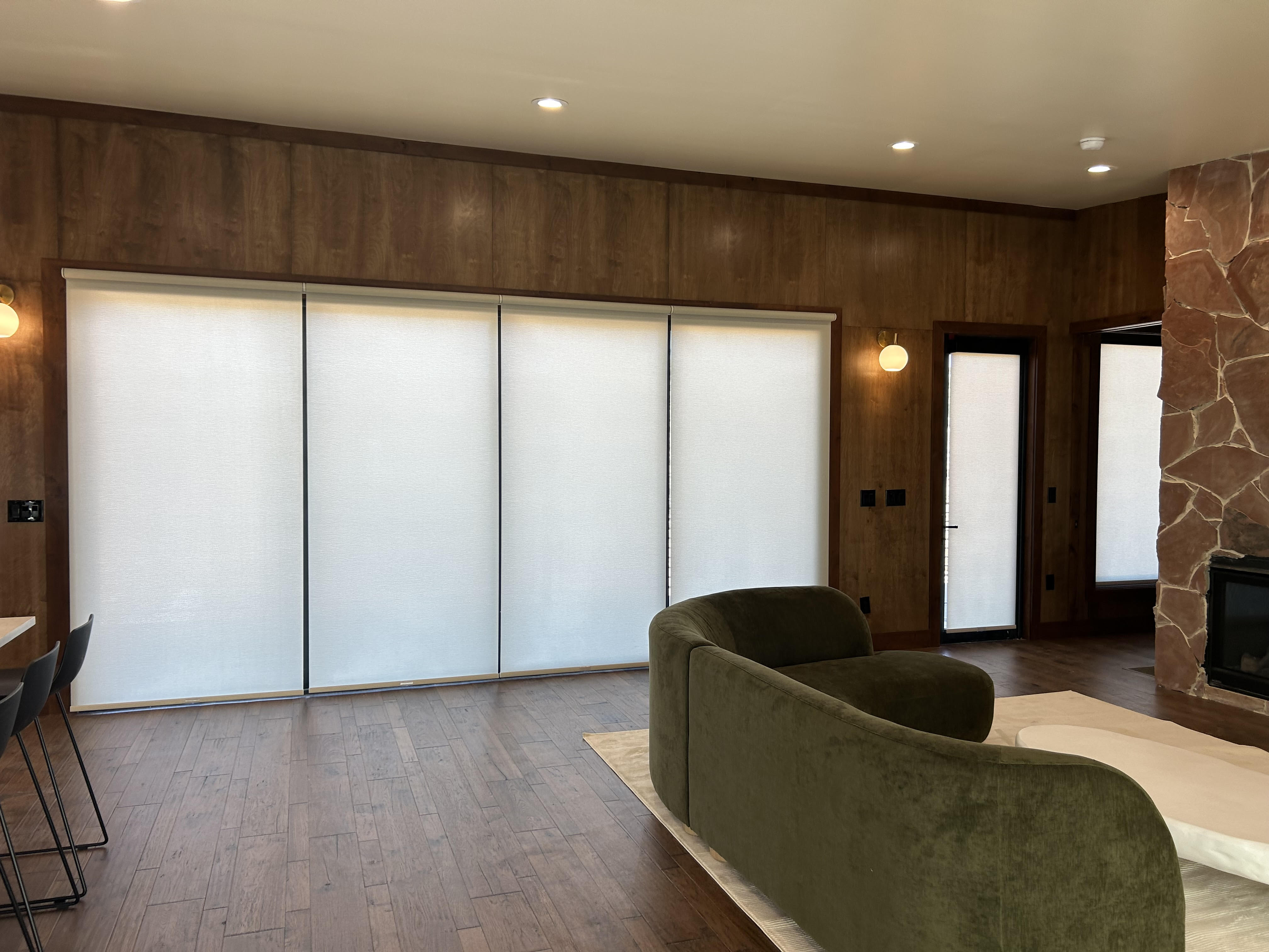 Roller shades in four windows inside country club