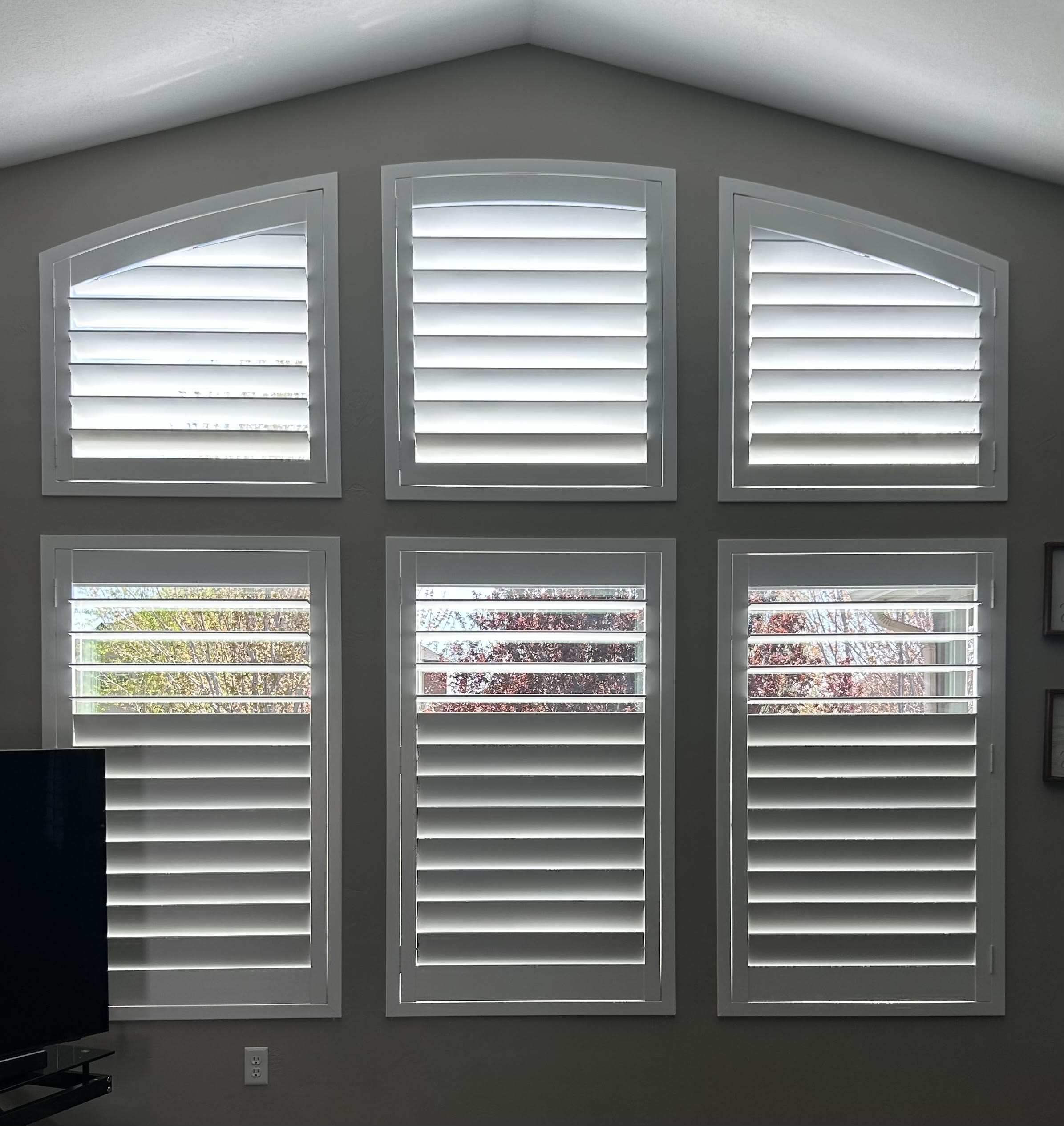Roller shades in four windows inside country club