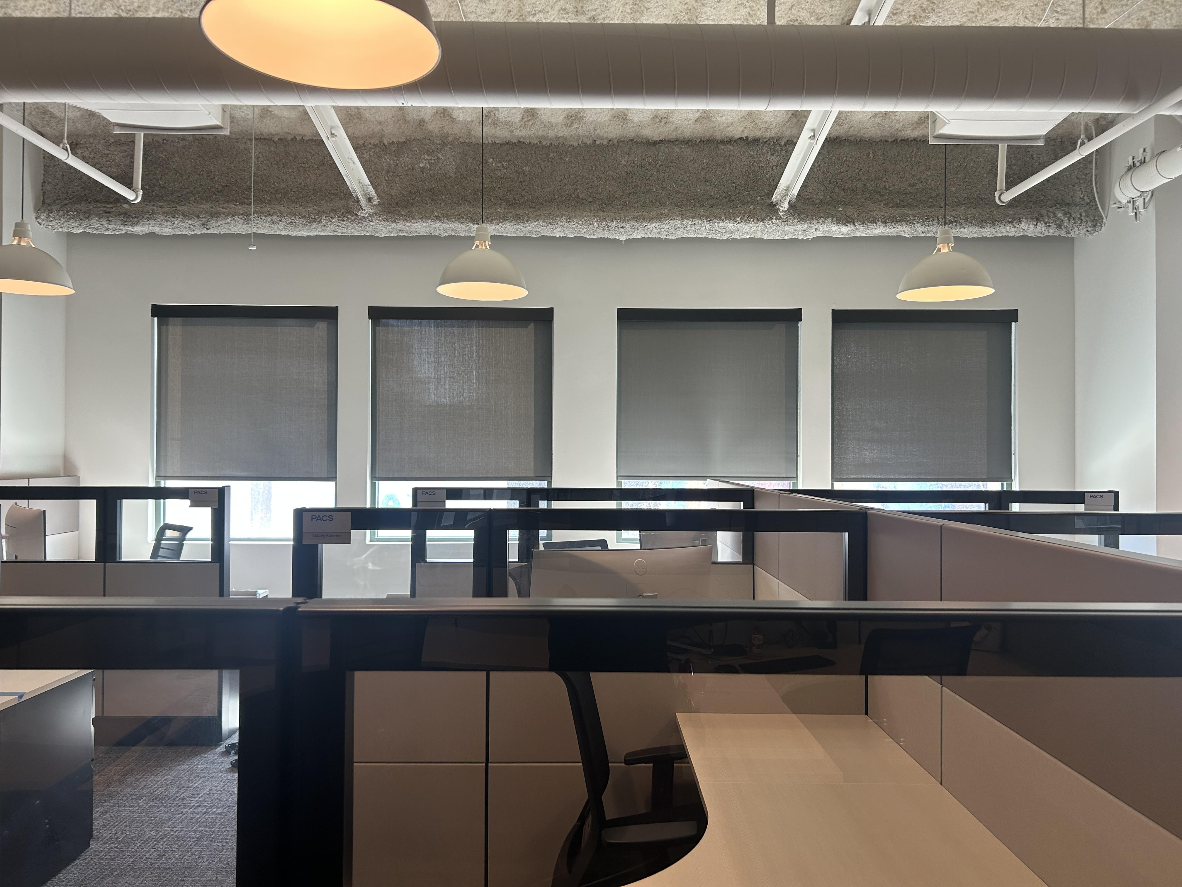 Roller shades in four windows inside country club