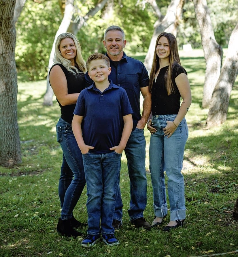 Fry family smiling gathered outdoors