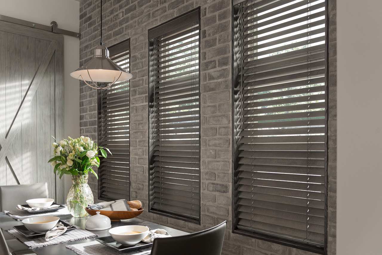 Beautiful wood and faux wood blinds in a modern living space
