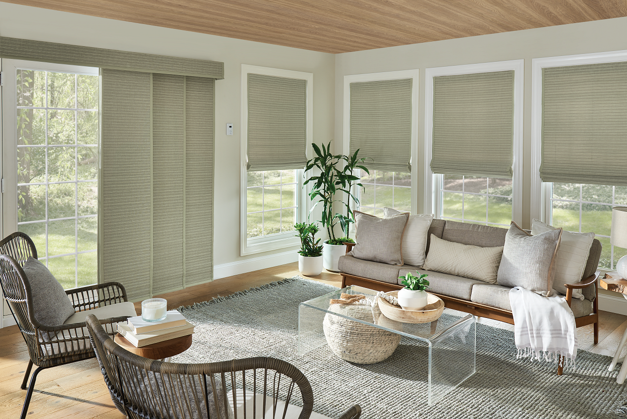 Natural woven shades in light neutral living room with mutliple windows