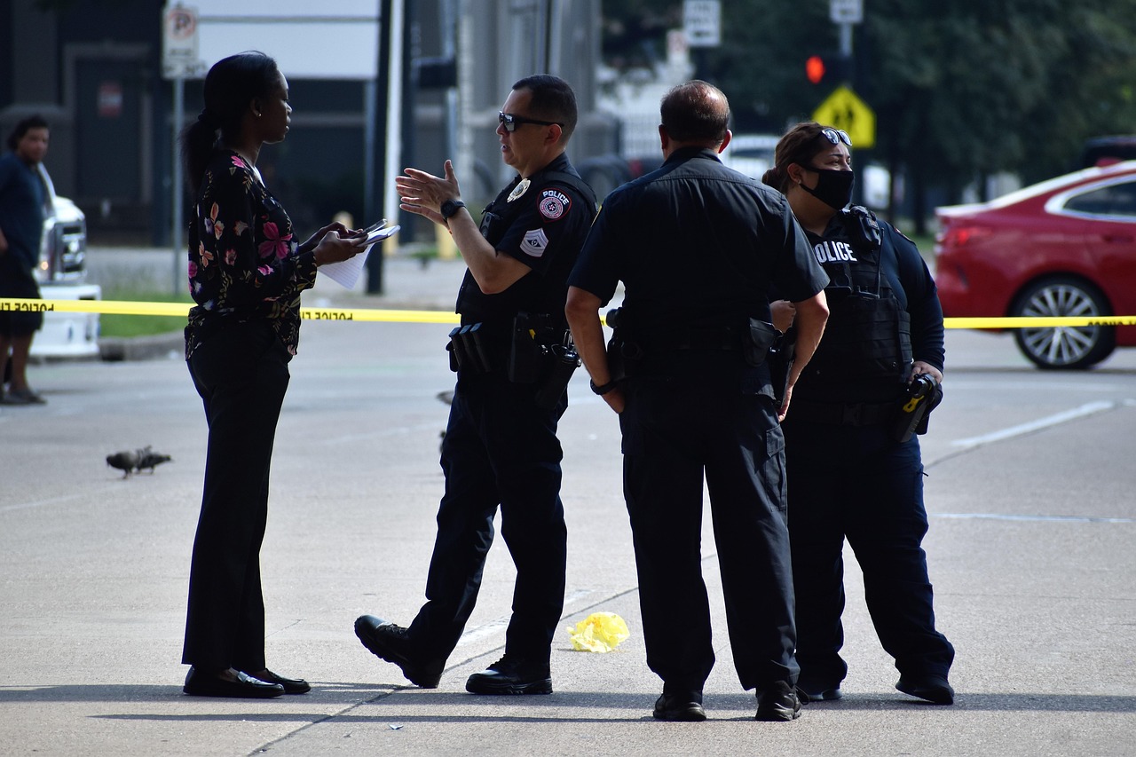 Police officer assisting with delivery during unusual event.