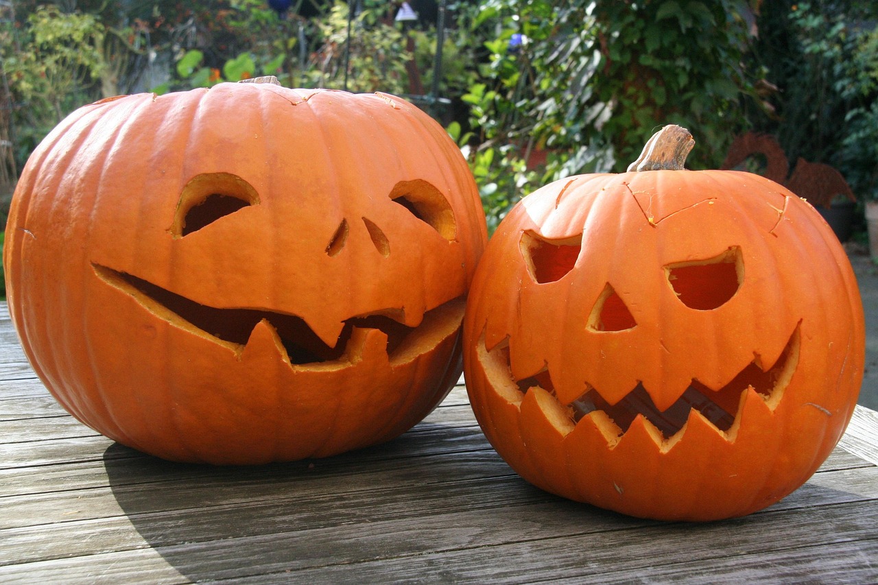 People in costumes at a pumpkin carving contest event.