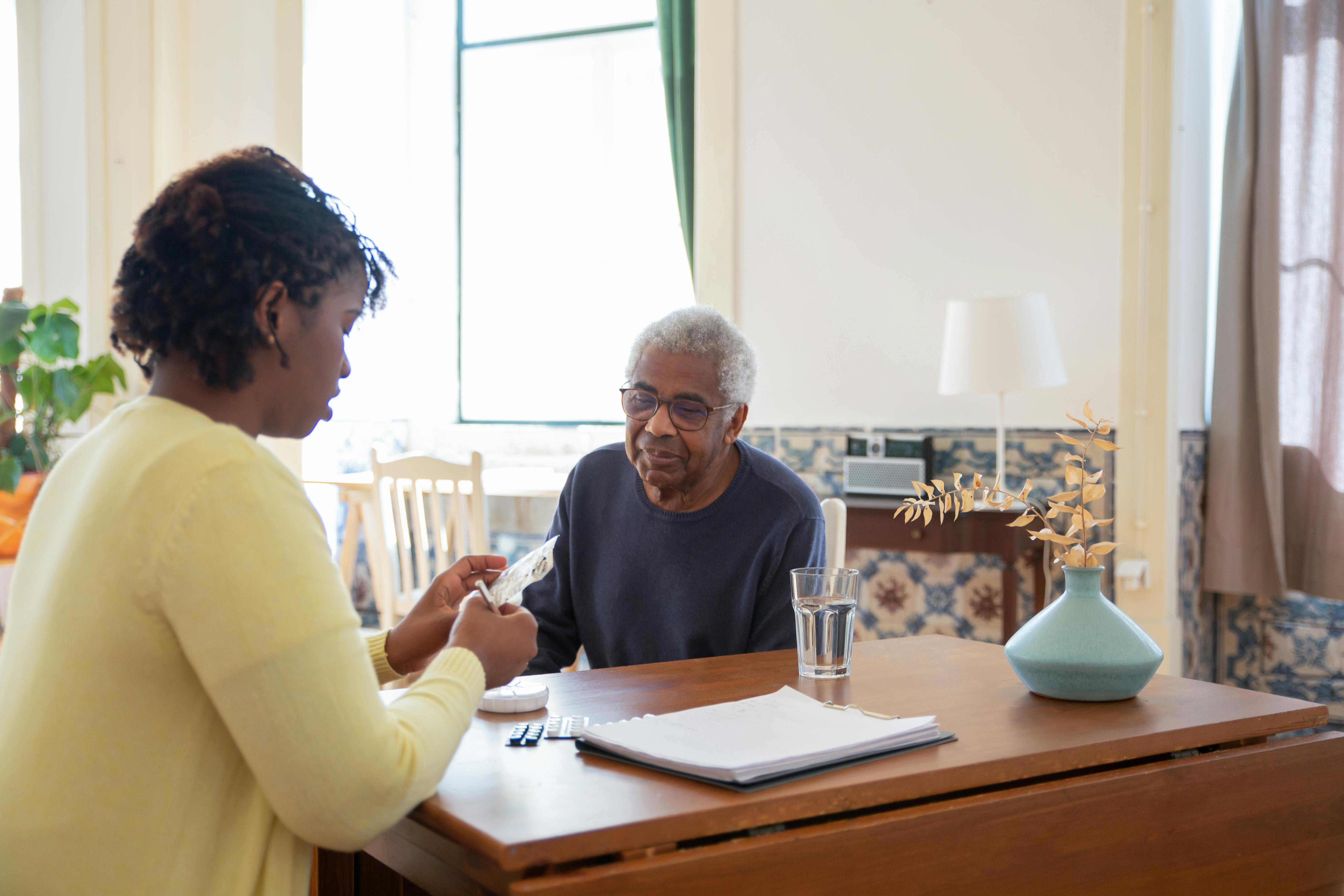 A caregiver offering warm, comforting support to a senior at home