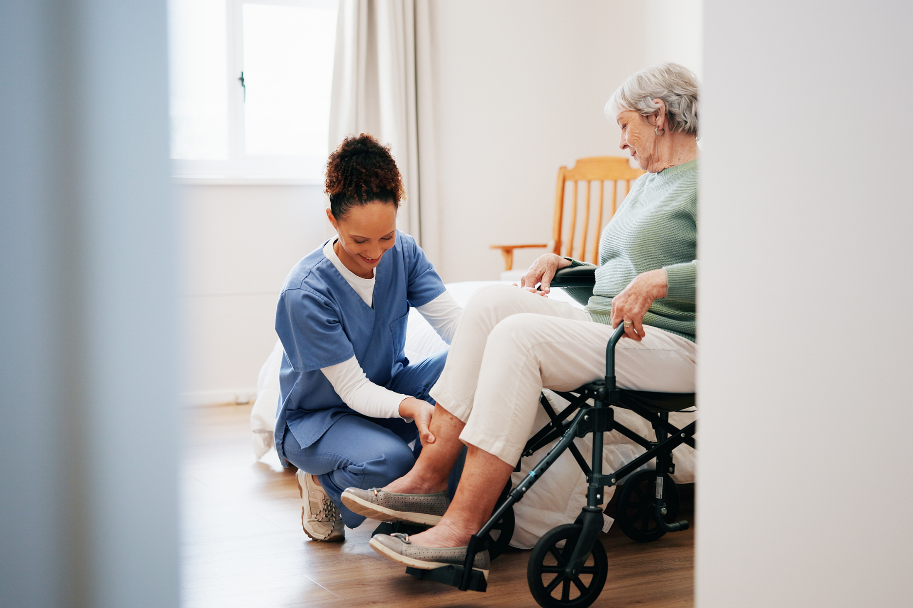 A caregiver sharing a warm moment with a senior client at home