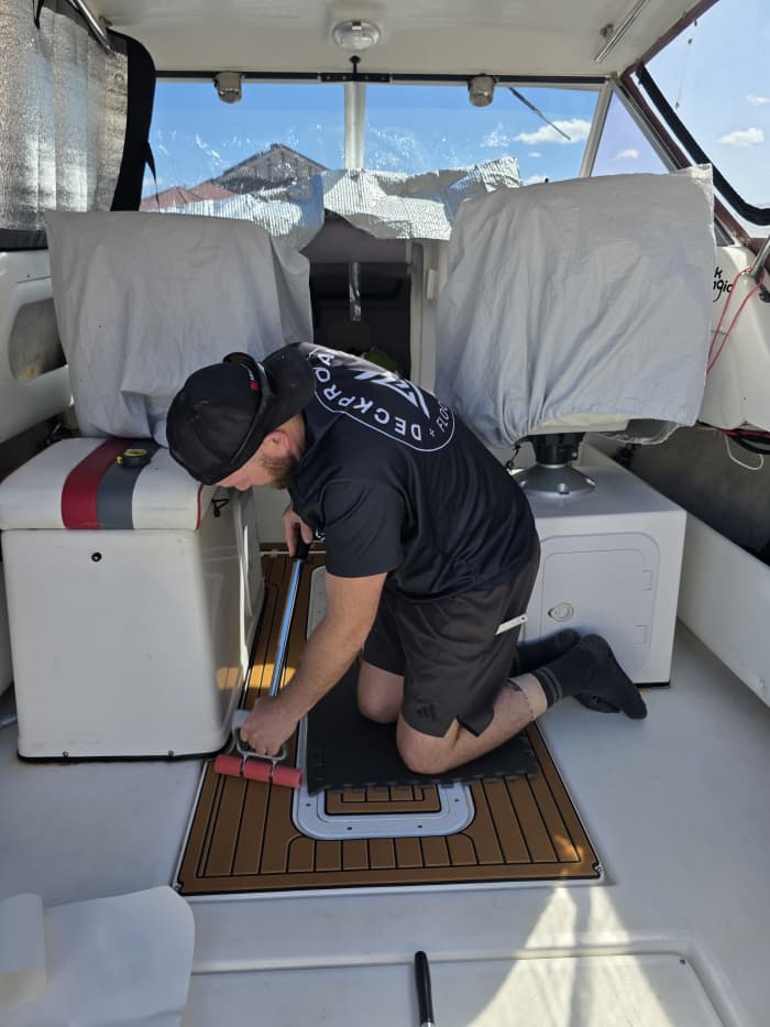 Professional marine flooring installation on a boat