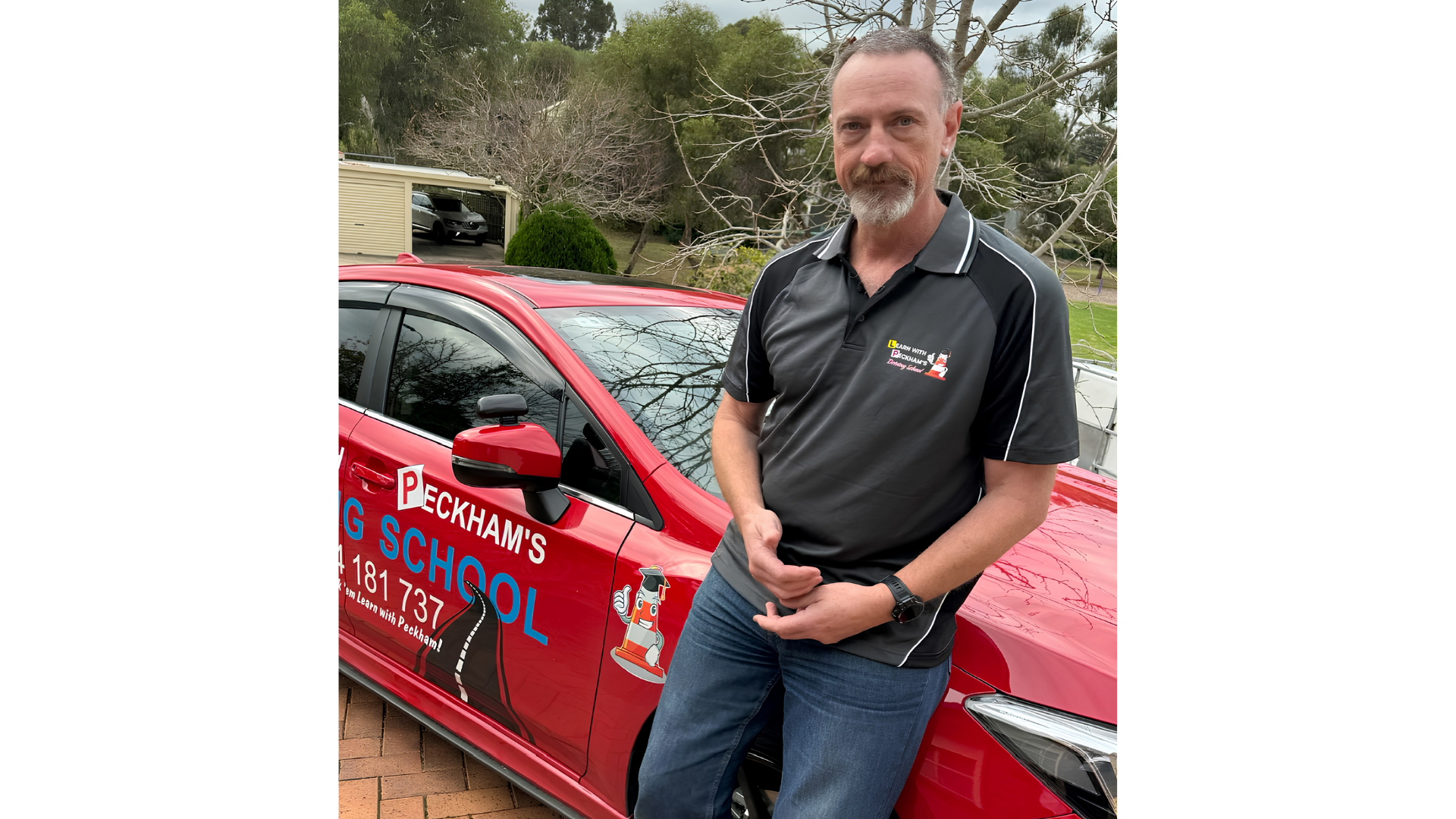 Bruce Peckham with his driving school car