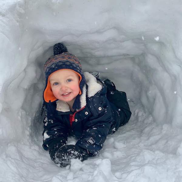 toddler snow outfit playing in the snow with best winter socks for toddlers